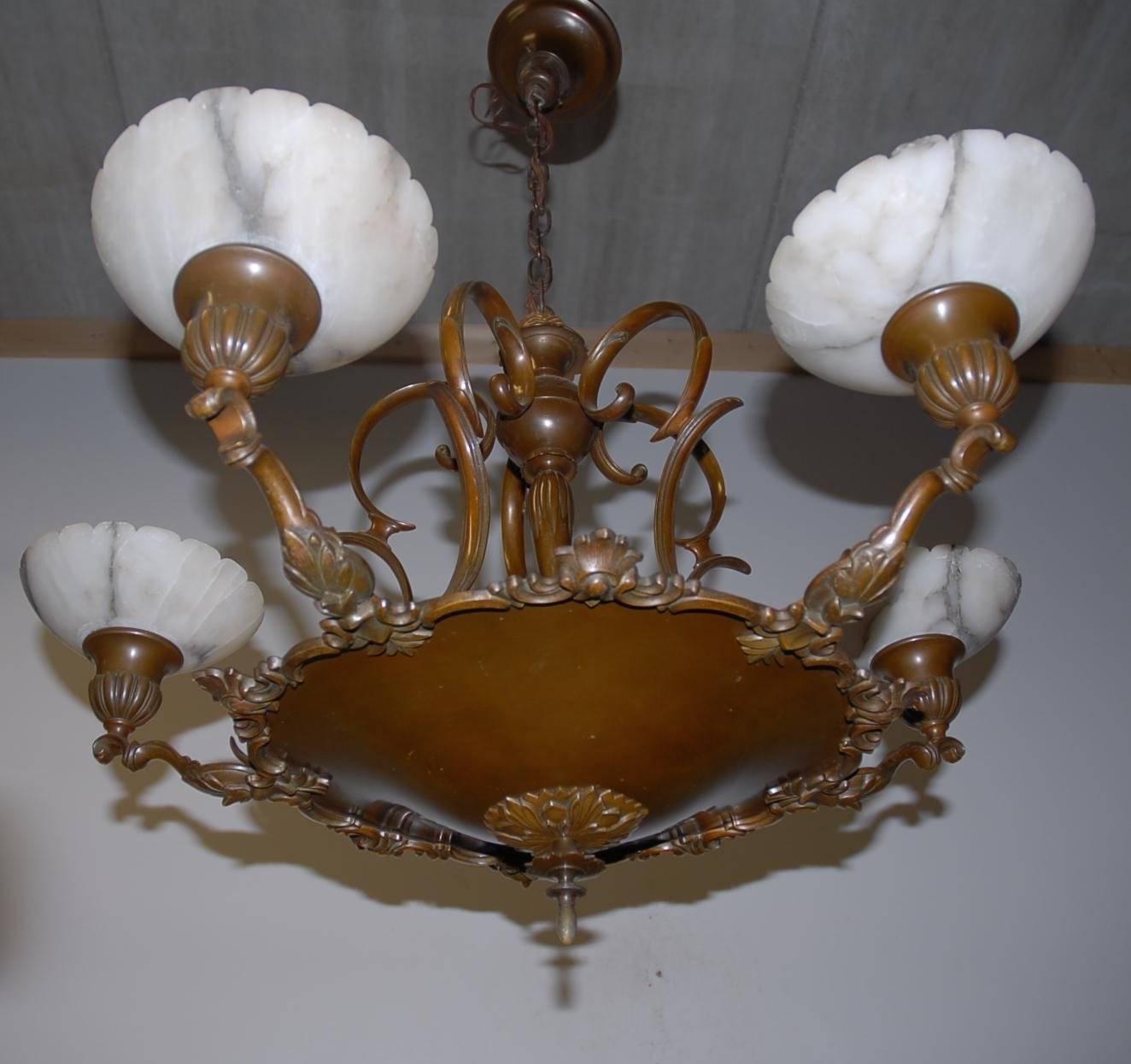 Beautiful and impressive bronze pendant.

If you are looking for the perfect lighting solution to one of your rooms then this elegant and great quality chandelier might be just that. This handcrafted pendant dates from circa 1910 and it has the most