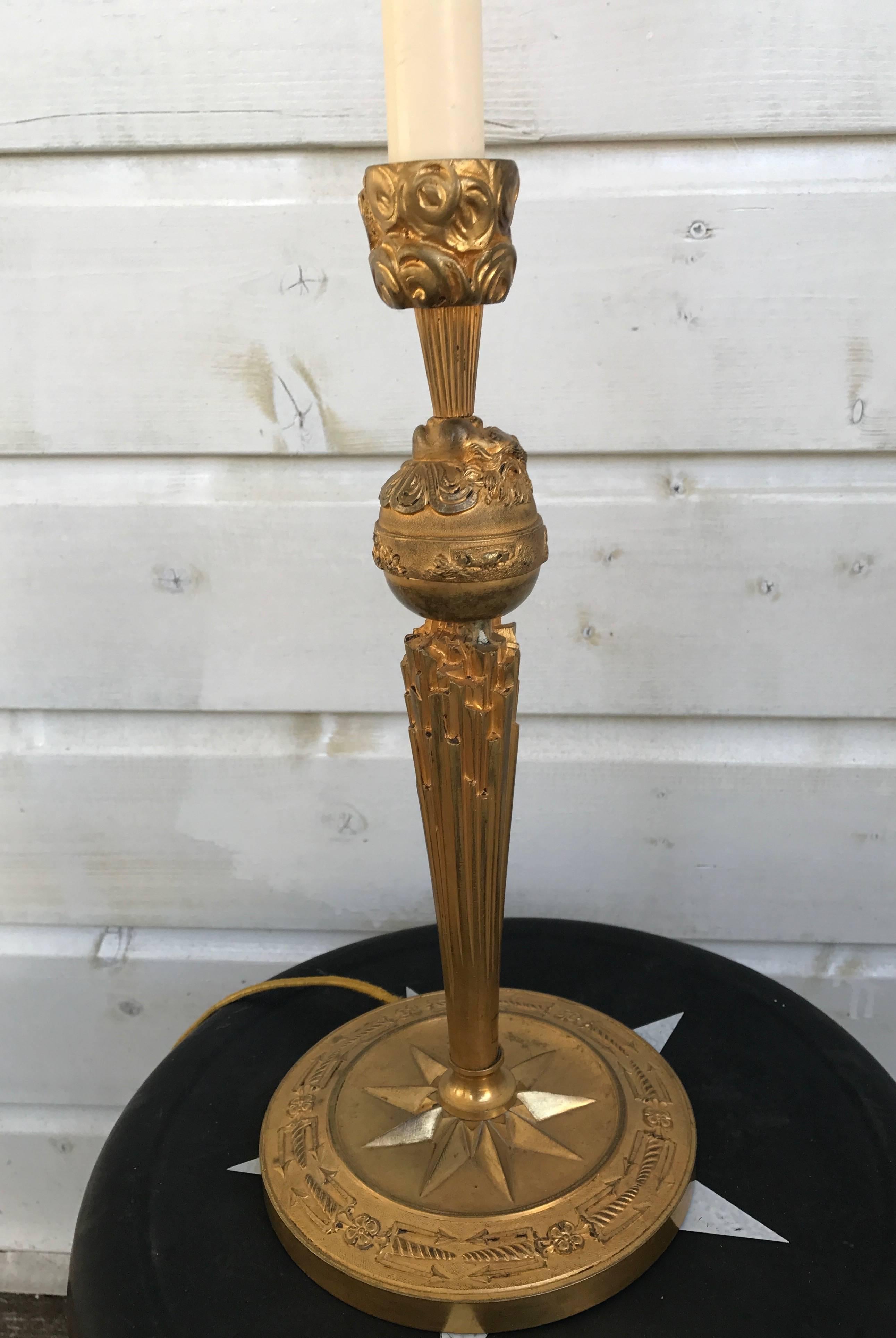 Figurative and intricate bronze table lamp.

This quality sculpted and cast bronze table lamp is beautifully gilded and it will make a wonderful talking piece. The plastic candle between the base and the socket was put there, because a linen shade
