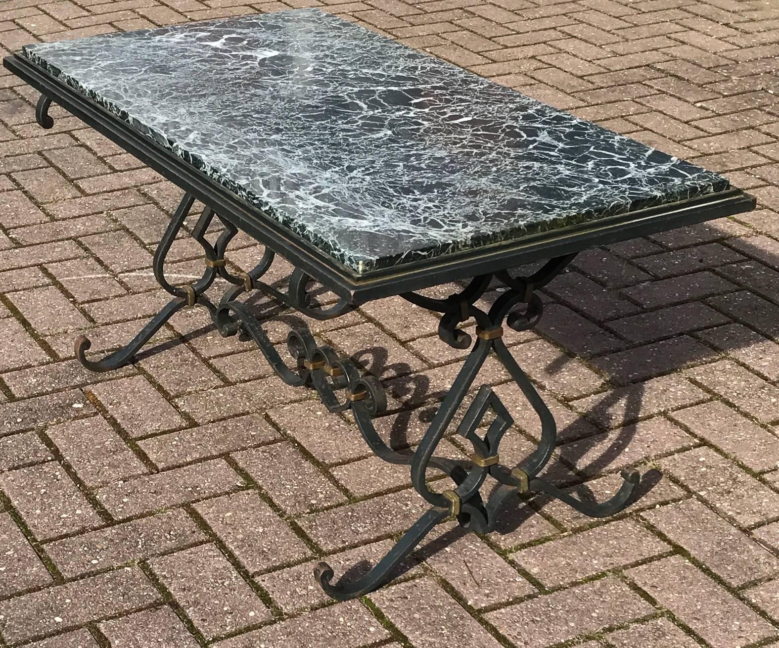 Good size, decorative coffee table from circa 1950.

If you are looking for a good quality and pleasing-to-the-eye centre or coffee table then this Fine example should be on your shortlist. The black and beautifully scrolling wrought iron base comes