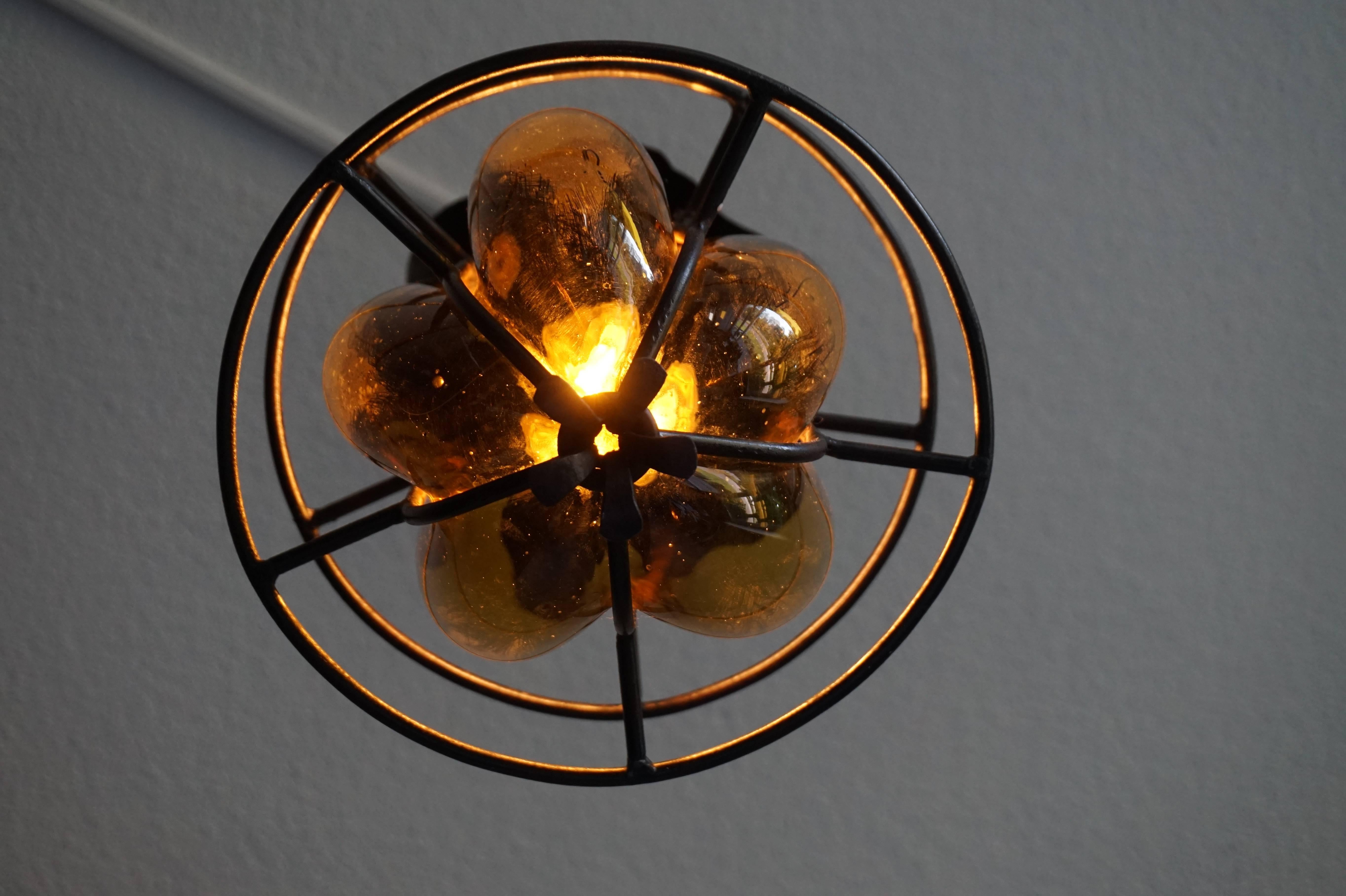 Original Arts & Crafts Pendant of Mouthblown Amber Glass in Wrought Iron Frame In Excellent Condition In Lisse, NL