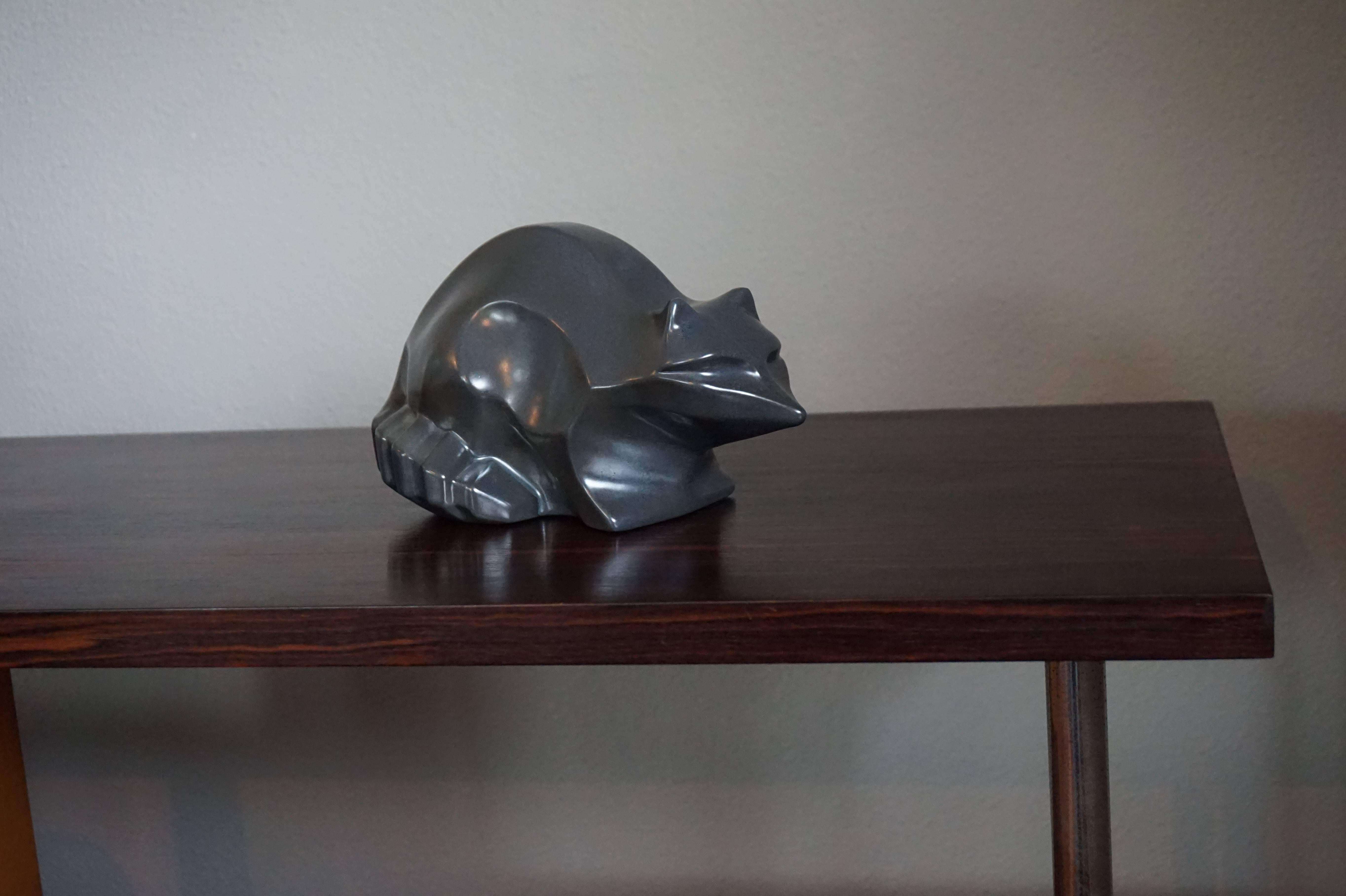 One of a kind, stylized racoon sculpture.

We have had this beautifully stylized racoon for a number of years now, but we never had it up for sale. We have tried to find out more about it, but this racoon is a bit of an enigma. We don't know who