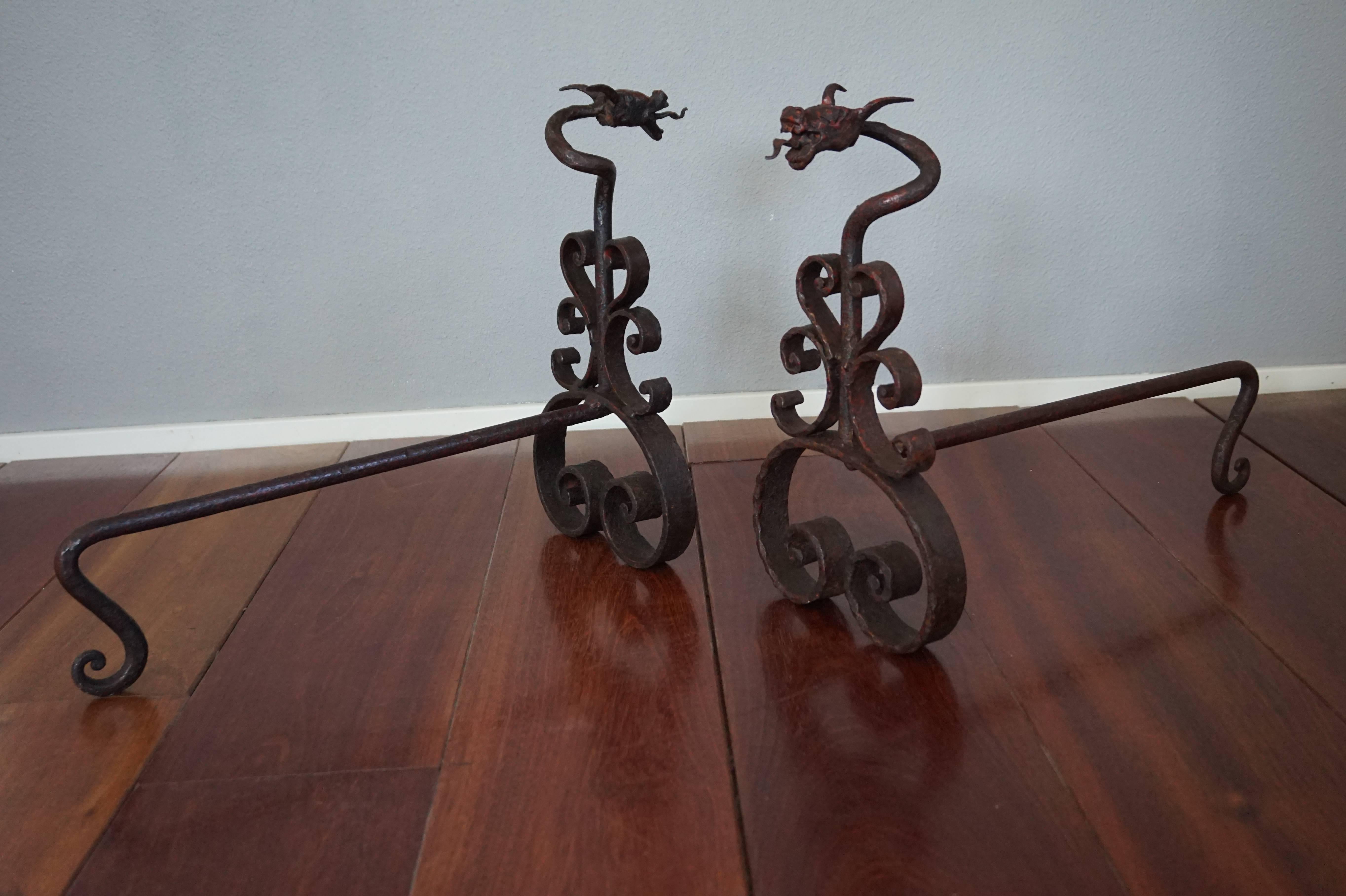 Imagine these in your fireplace with the flames burning on all sides.

These beautifully and all handcrafted wrought iron, andirons are made to stand in your fireplace as in image number one, but then straight forward. The idea is to put your loggs