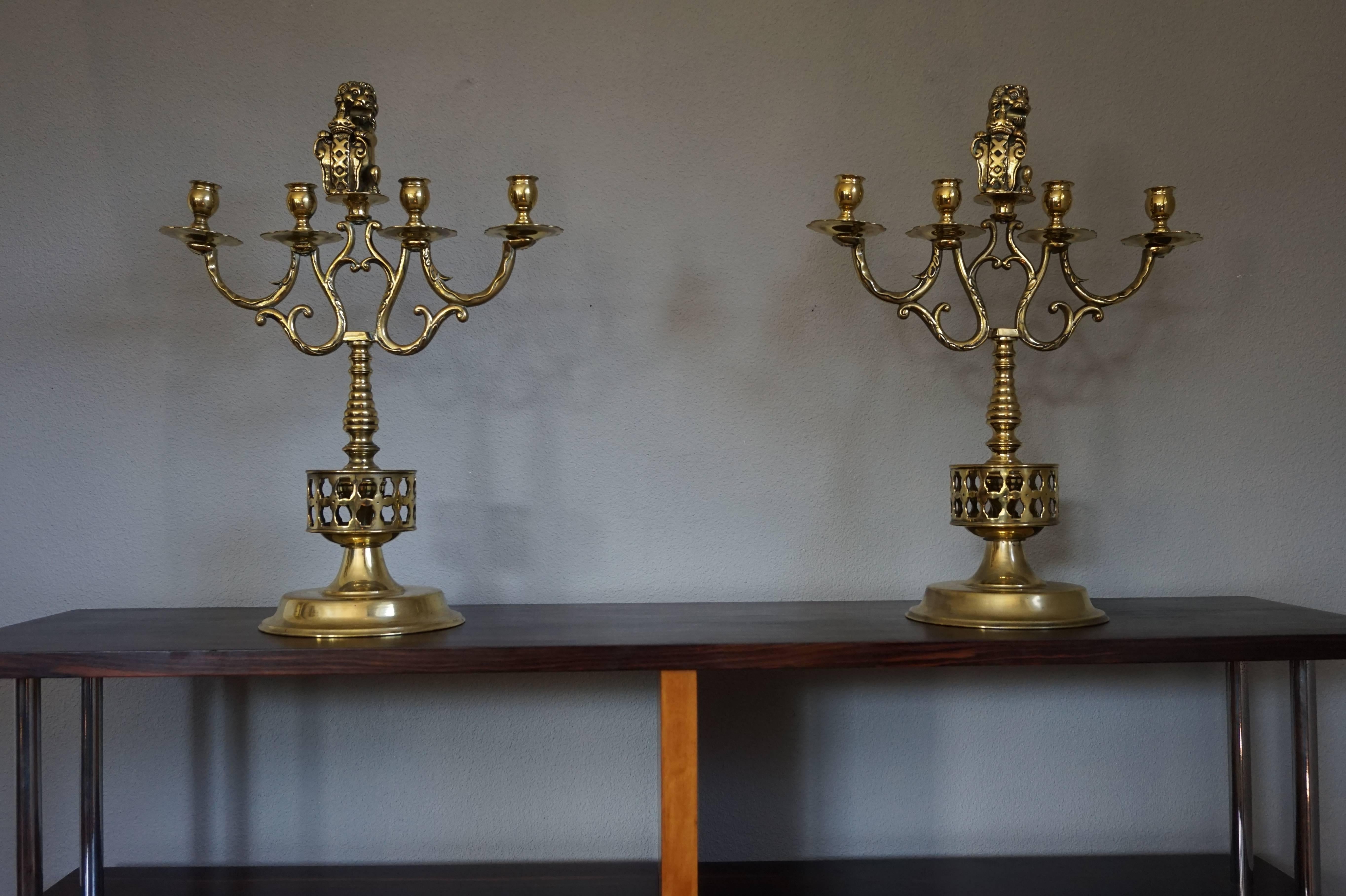 Large and beautiful pair of solid brass candelabras.

These large and fine quality brass candelabras are much more impressive in real life than they could ever look in a picture. This early twentieth century pair comes with a stylized coat of arms