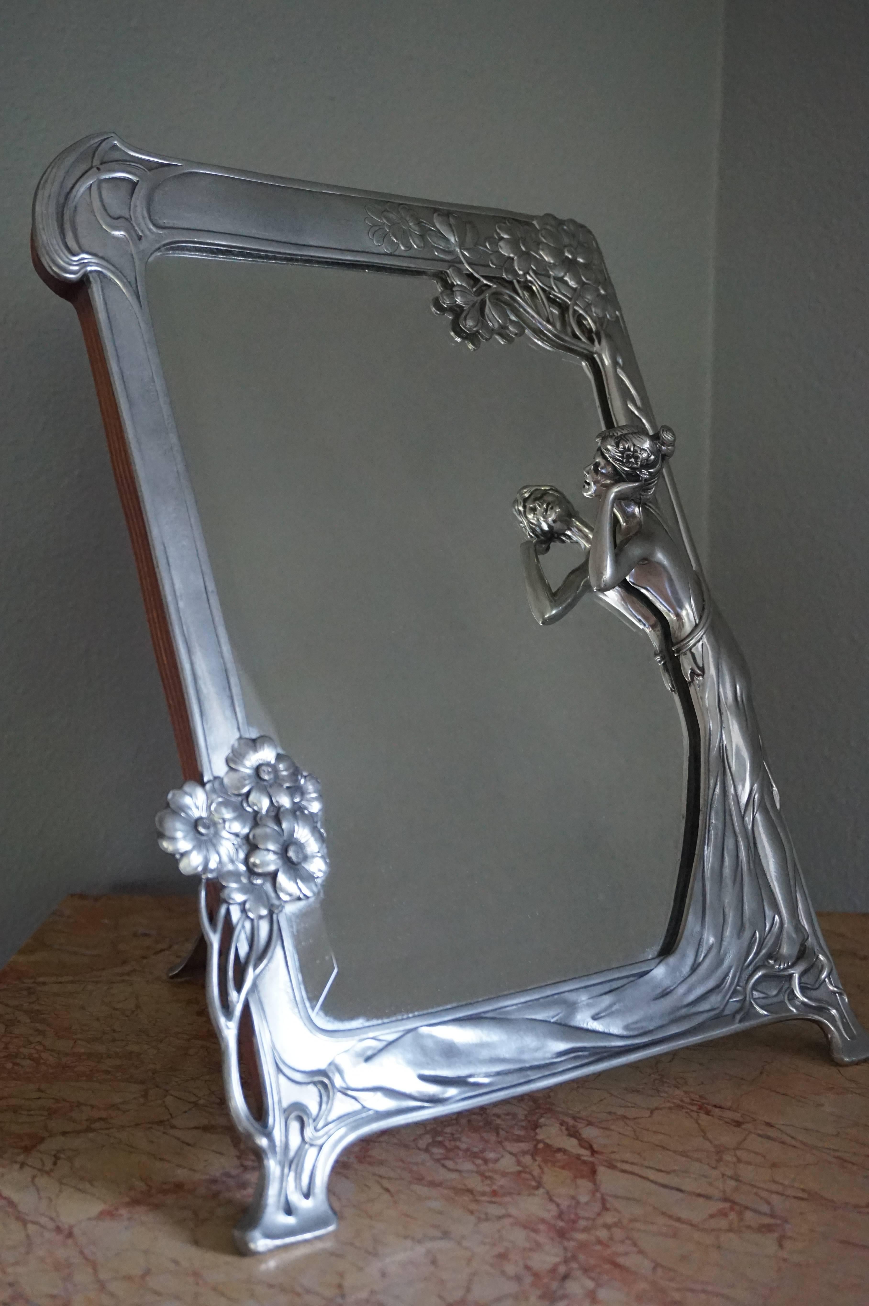 Wonderful and decorative mirror.

If you are looking for rare and elegant Art Nouveau pieces then this table mirror should be on your shortlist. This stunning mirror frame with a most elegant and integrated lady sculpture is made of pewter and the
