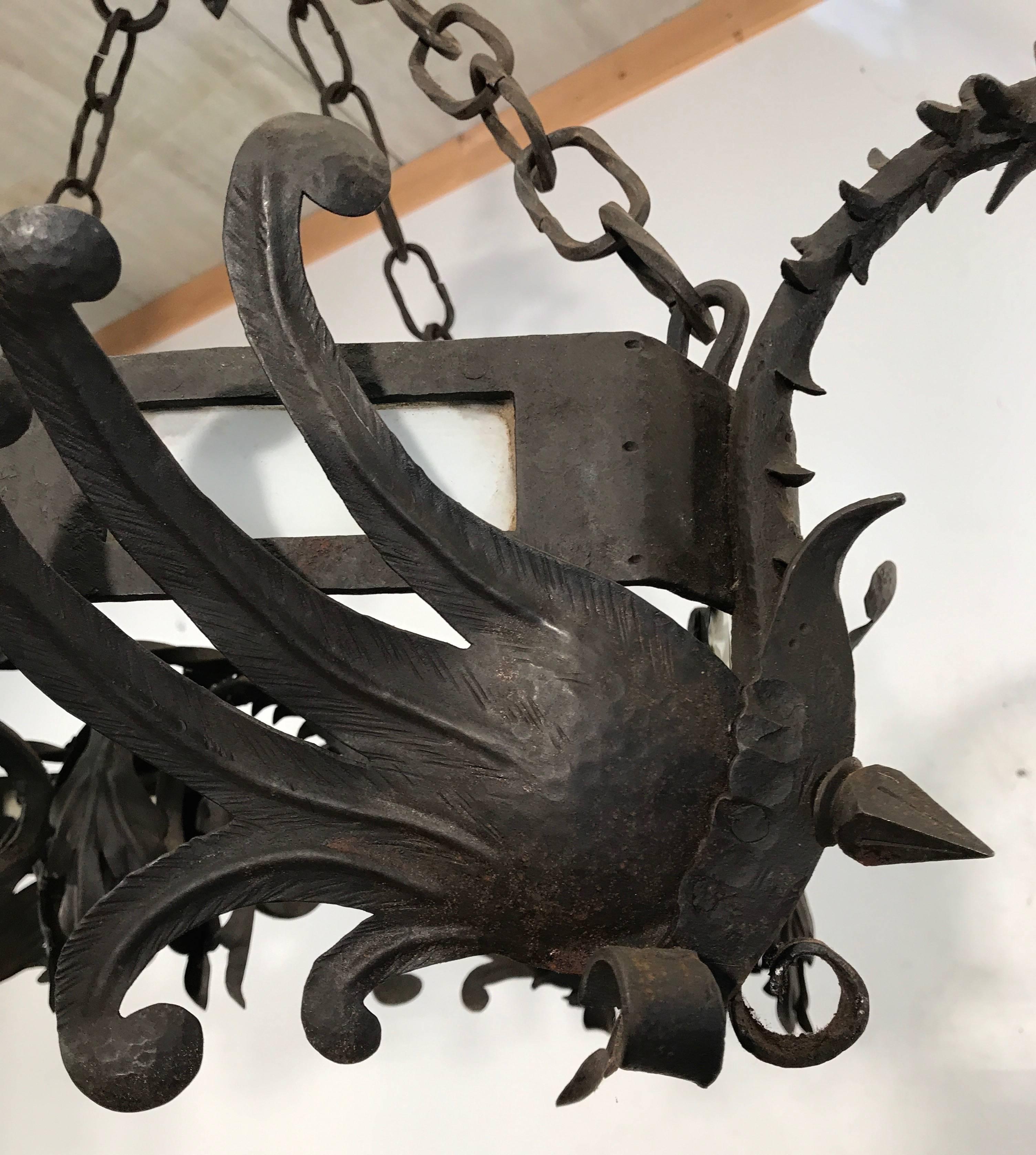 20th Century Unique Hand Forged Wrought Iron Chandelier with Four Winged Griffin Sculptures For Sale