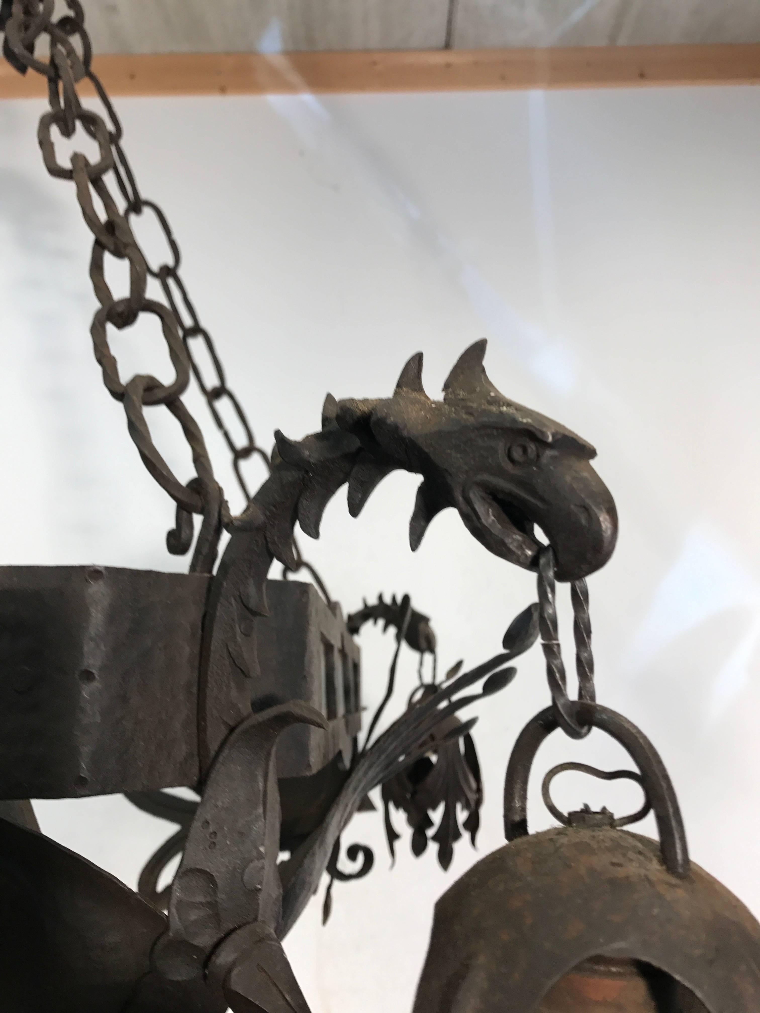 Antique Italian handcrafted work of lighting art.

This amazing handcrafted five-light chandelier from Tuscany, Italy comes with a hand-forged griffin sculpture on each corner. The design and execution of this wrought iron pendant is simply