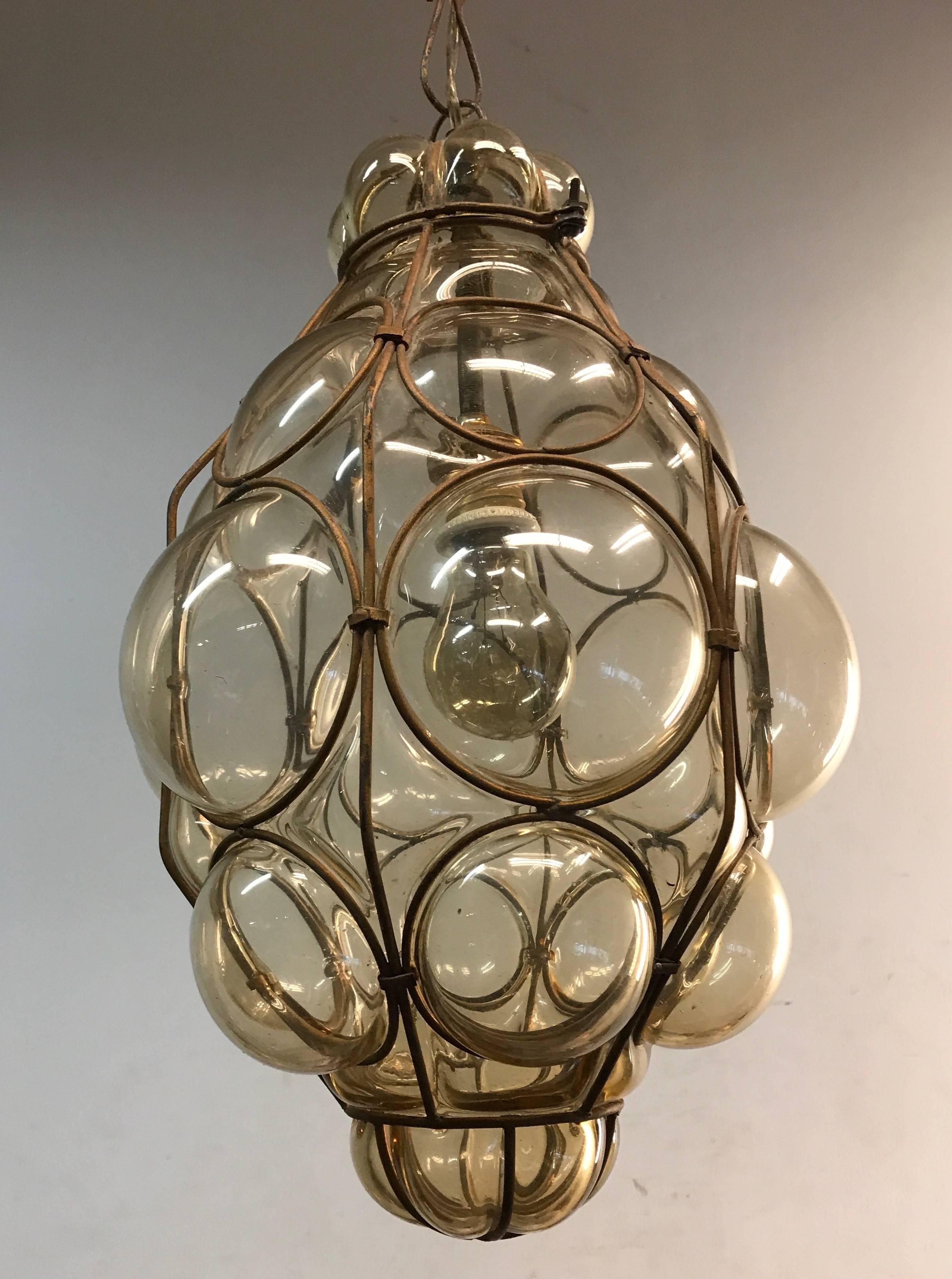 Early 20th century, Italian craftsmanship pendant.  

This stylish single light pendant is beautiful in shape and the mouth blown, bronze tinted glass is in excellent condition. It comes with the original chain and metal canopy and the bulb can