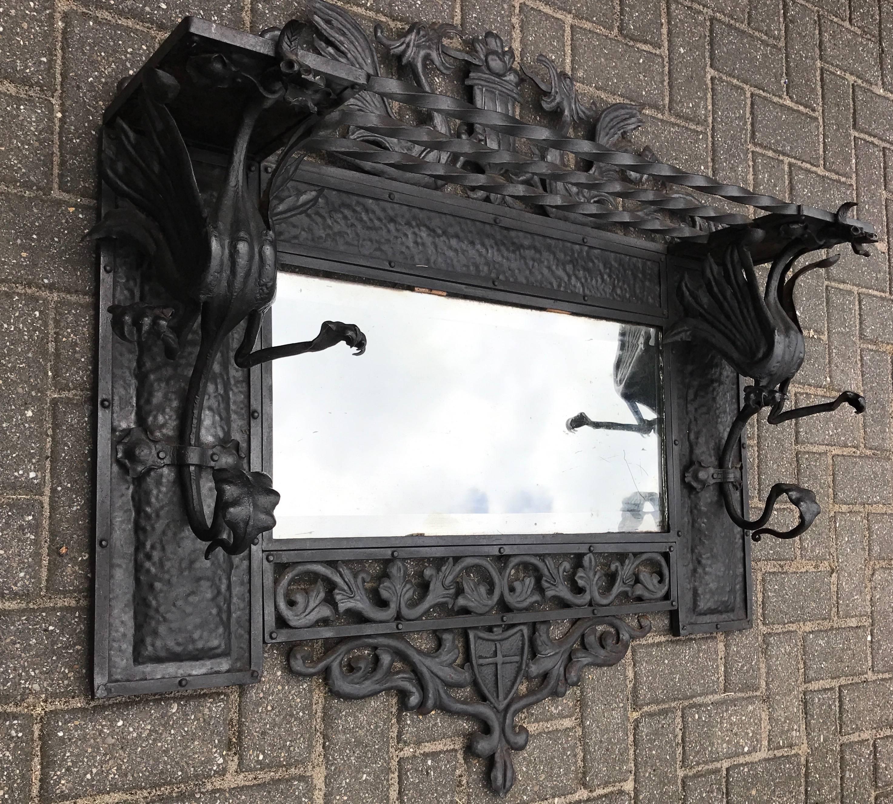 Rare and impressive coat rack with forged dragon sculptures. 

This rare and handcrafted work of blacksmith art can be used as a wall mirror, but also as a coat rack in your hallway. It has a hat rack on top and the dragon's tails and claw feet can