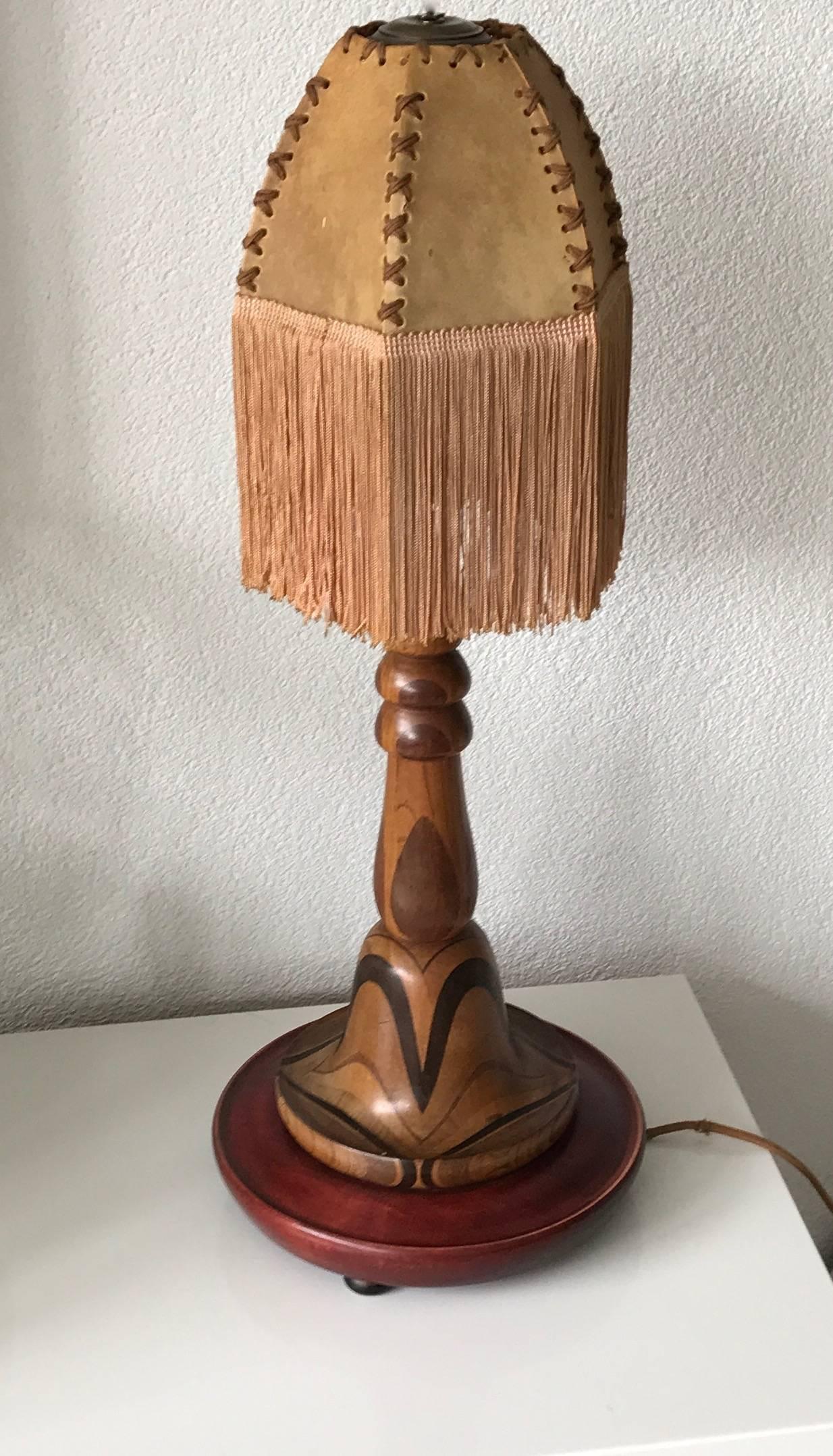 Beautiful Art Deco table lamp from the 1920s.

This wonderfully crafted Art Deco lamp is of a great and pleasing to the eye design and it comes with a perfectly matching hide shade. It is in original and magnificent condition and what makes this