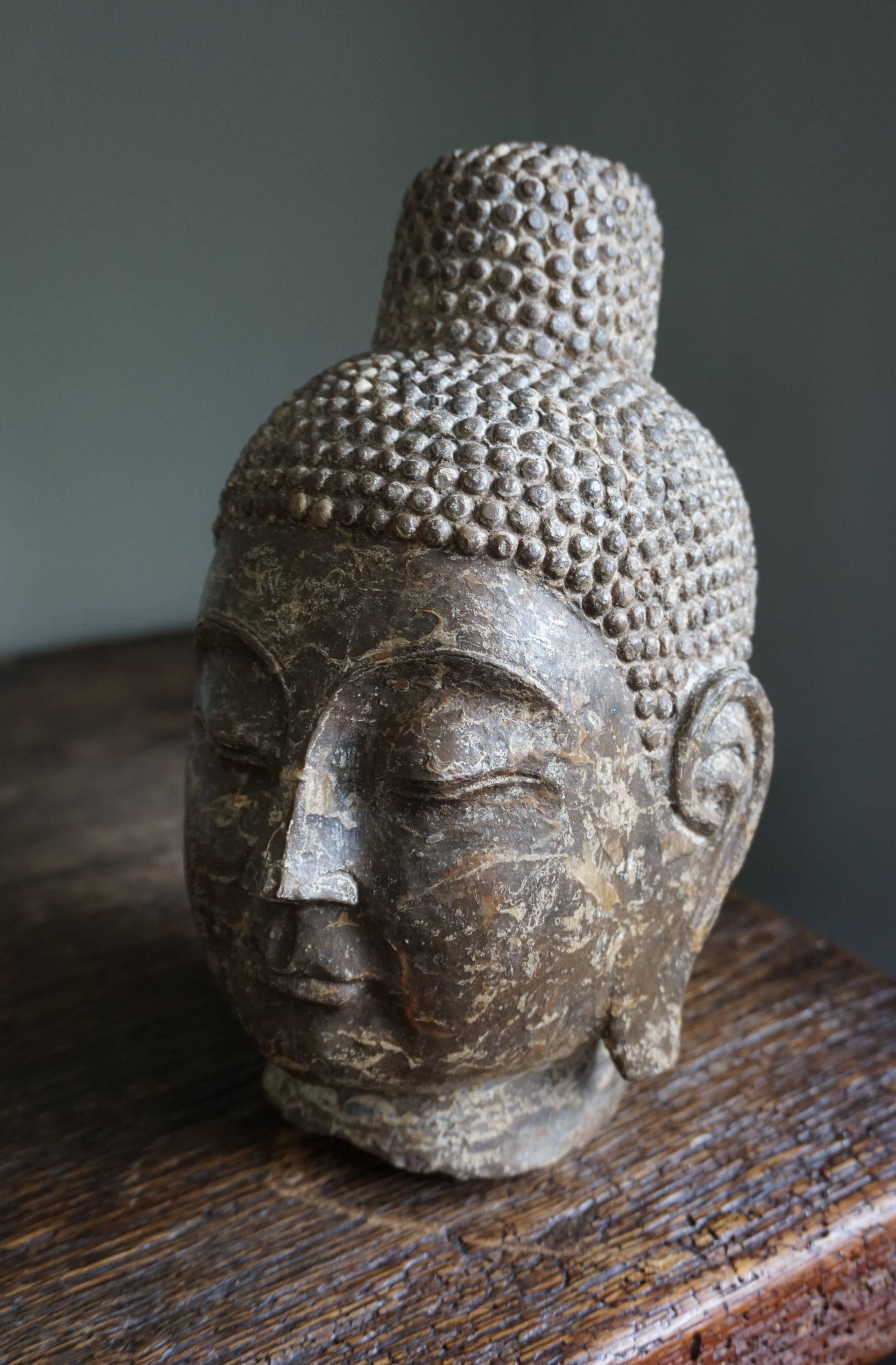 Stunning and one of a kind Buddha sculpture.

There are only very few people in the world who can accurately date this hand-carved marble bust/head of Gautama Buddha. Unfortunately, we do not know people who can. We did find out that this Buddha is