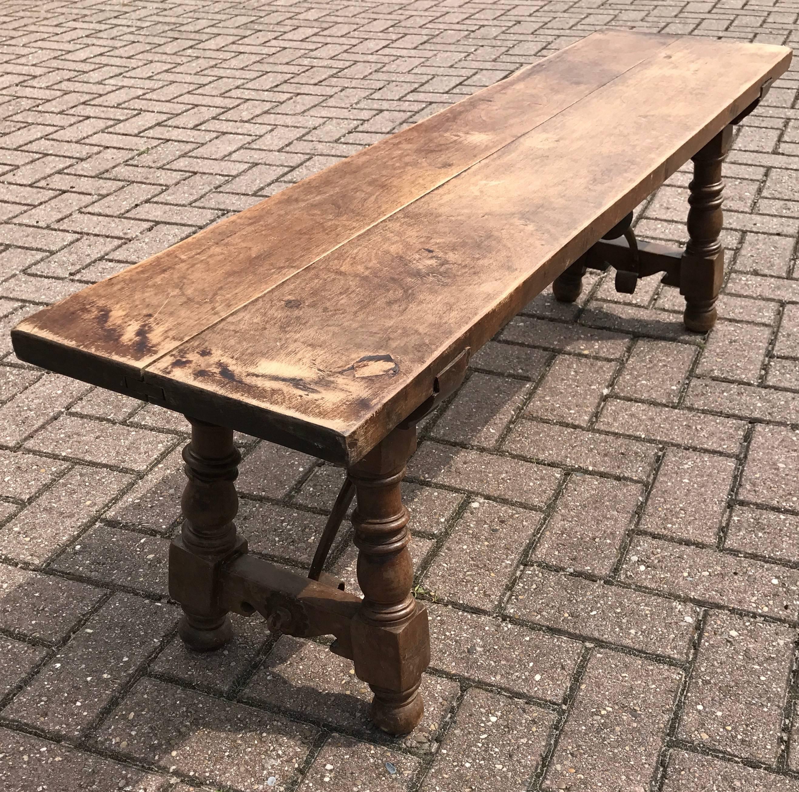 Sturdy, stylish and practical, antique Spanish bench.

This early twentieth century Spanish bench comes with a thick and strong wooden top. This bench is raised on two hand-turned wooden legs and both are connected to the seat by exquisitely curved