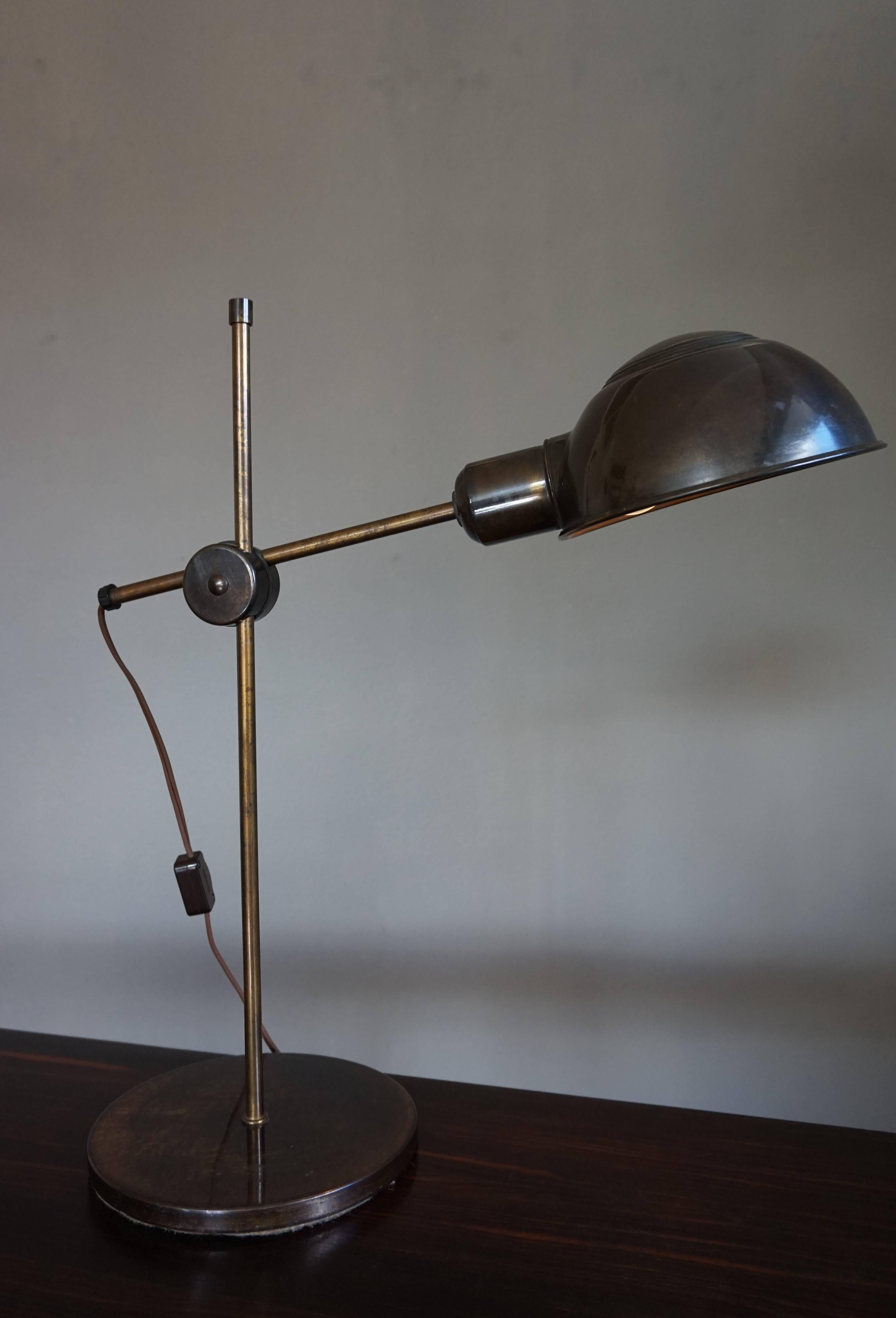 Unique on 1stdibs and very rare in the world.

This timeless and stylish table or desk lamp dates from the Mid-Century Modern era. By turning the butterfly nut, the arm with the lampshade can be moved forward, backward, up, down and to all sides.