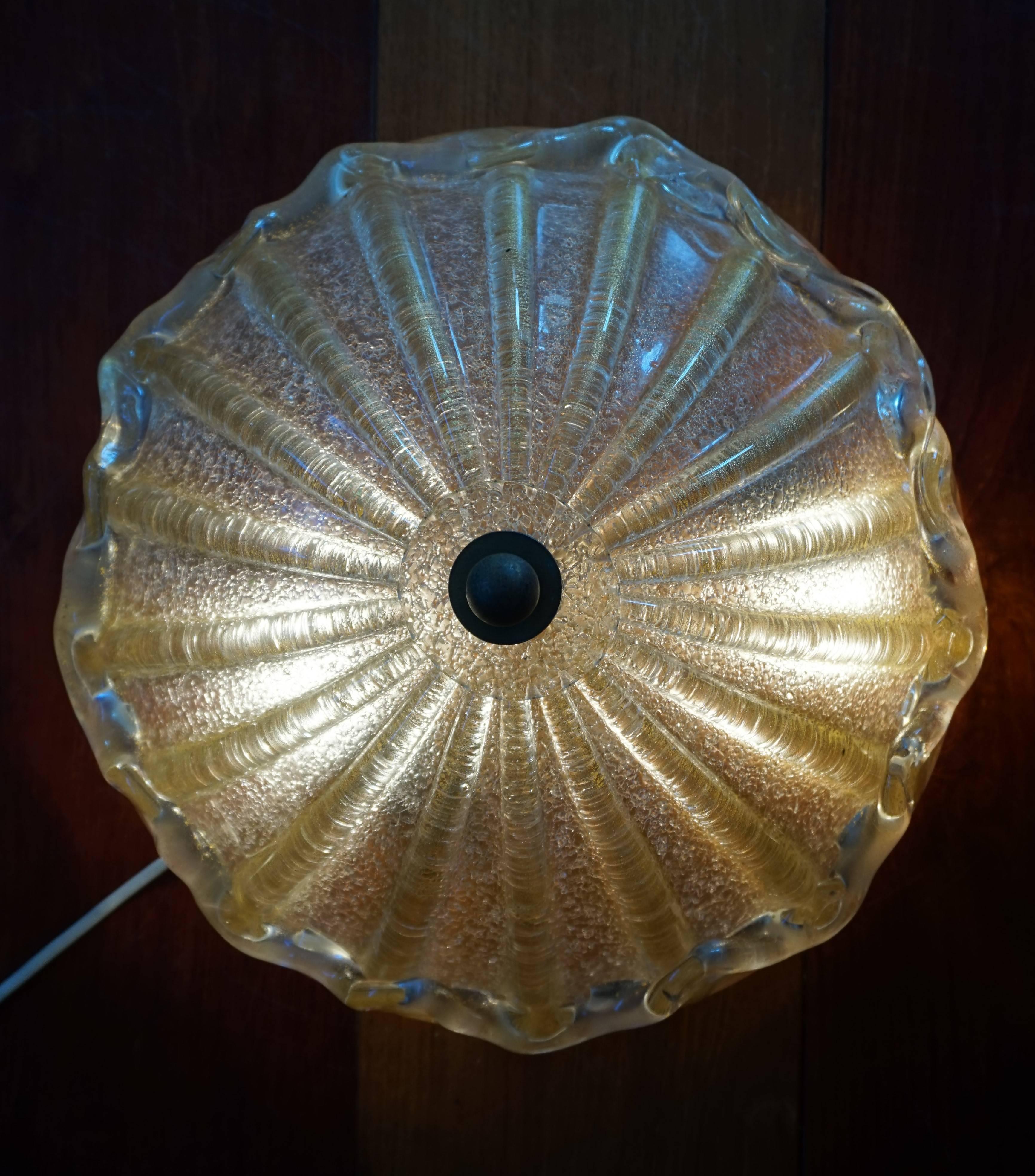 Handcrafted and mouthblown Seguso Murano ceiling lamp.

We actually bought this stunning Murano flush mount from the first owner. She had acquired it in the late 1950s from a well respected, Amsterdam based dealer in high-end furniture and lighting