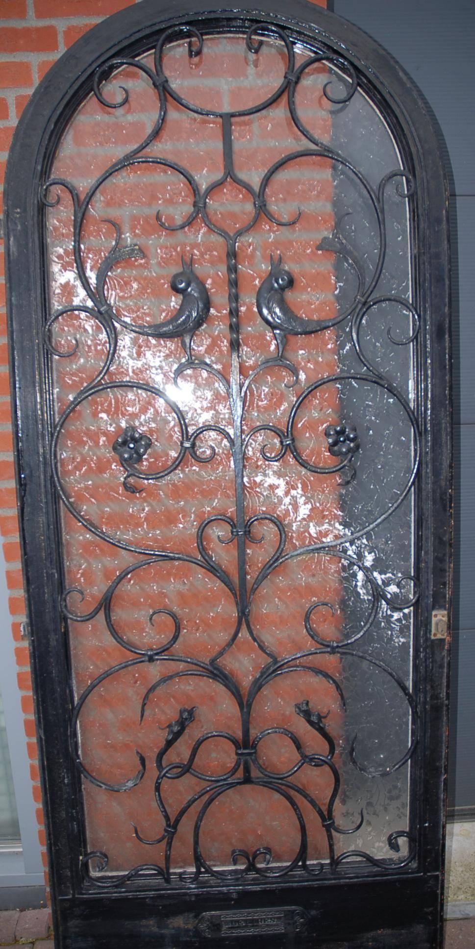 Heavy quality iron door with acid etched, flowery decor glass window.

This rare and beautiful entry door is also a work of art. If first impressions count then anybody walking up to this handcrafted door will immediately be impressed. You simply