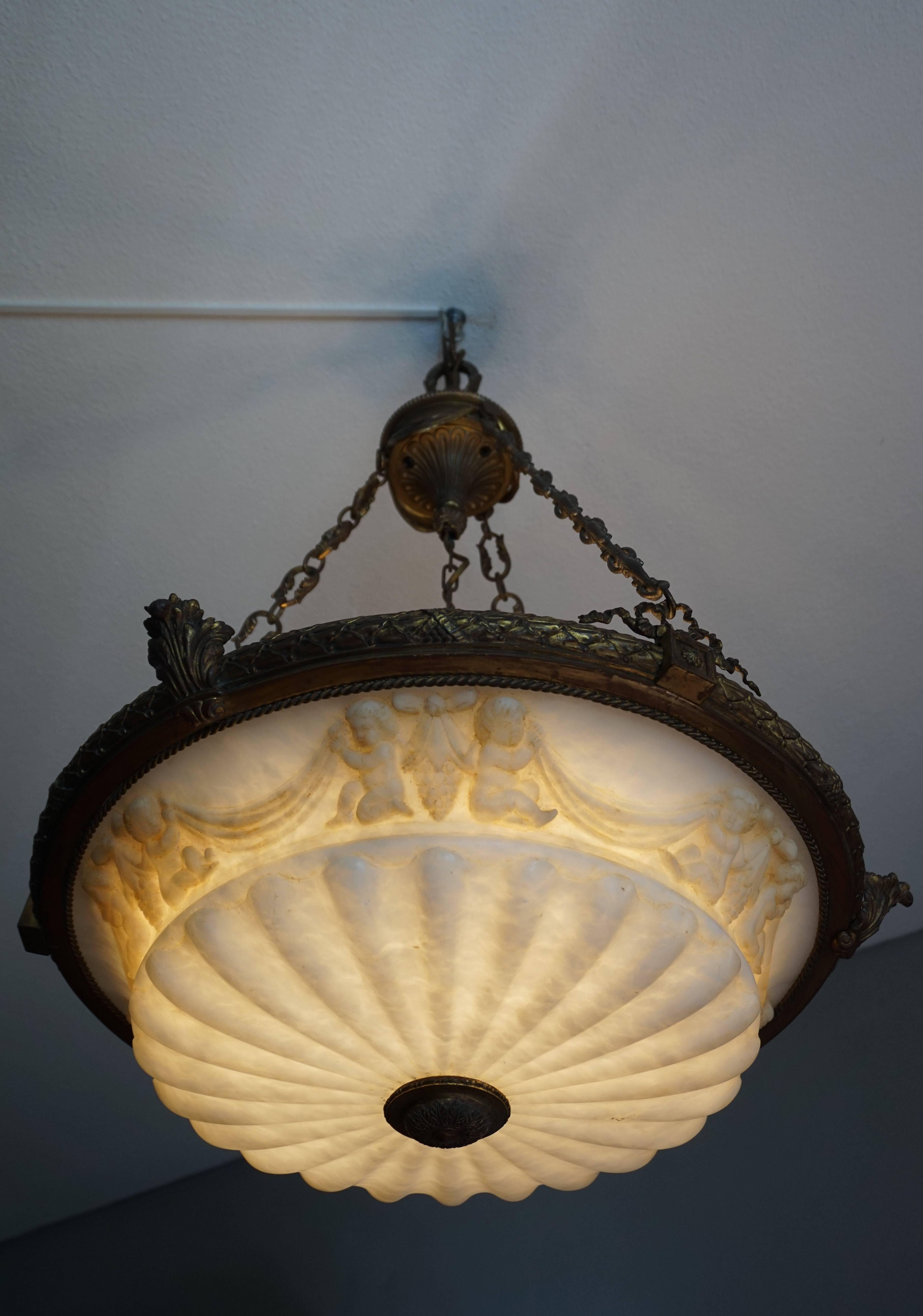 Five-light chandelier with a marvelous alabaster shade and three removable, double candalabras.

We salvaged this large and majestic pendant from a house that was built in the 1880s. It was hanging from a 12 feet high entrance ceiling and we