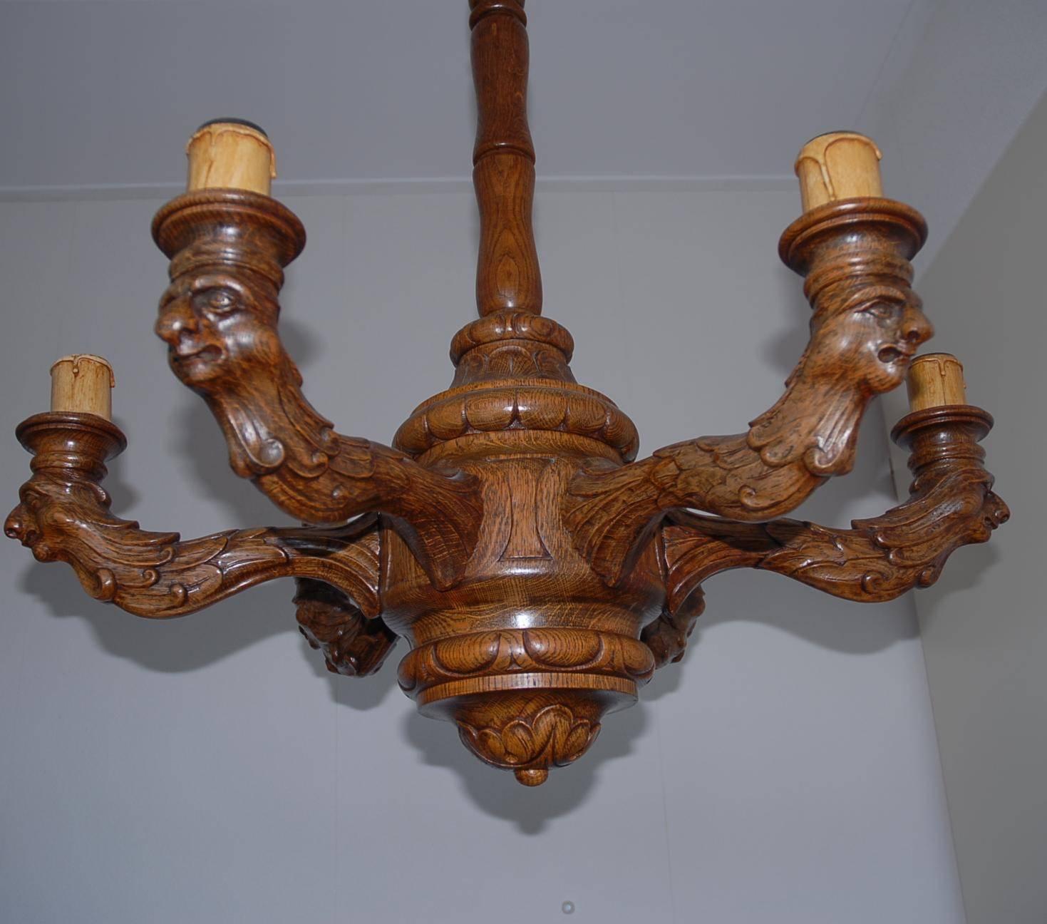 Stunning hand-crafted pendant with a great patina.

This stunning chandelier clearly is the result of the skilled and focused craftsmanship of a master carver. To be able to carve one of these mythical fantasy sculptures is one thing, but to be able