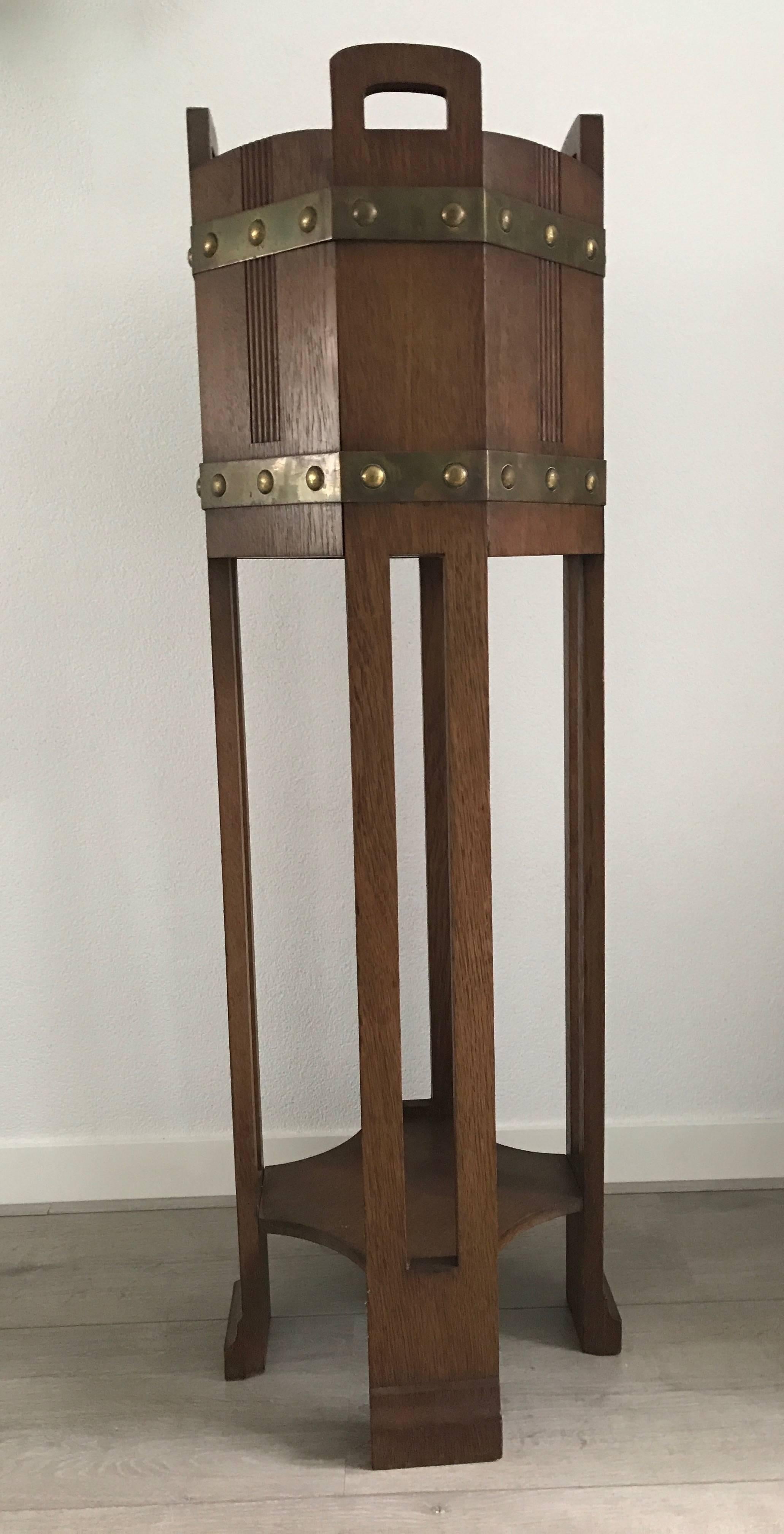 Handcrafted antique jardinière.

This early 20th century stand is a fine example of the craftsmanship and the wonderful designs of the Arts and Crafts movement. This rectangular design has a great patina and the combination with the copper bands