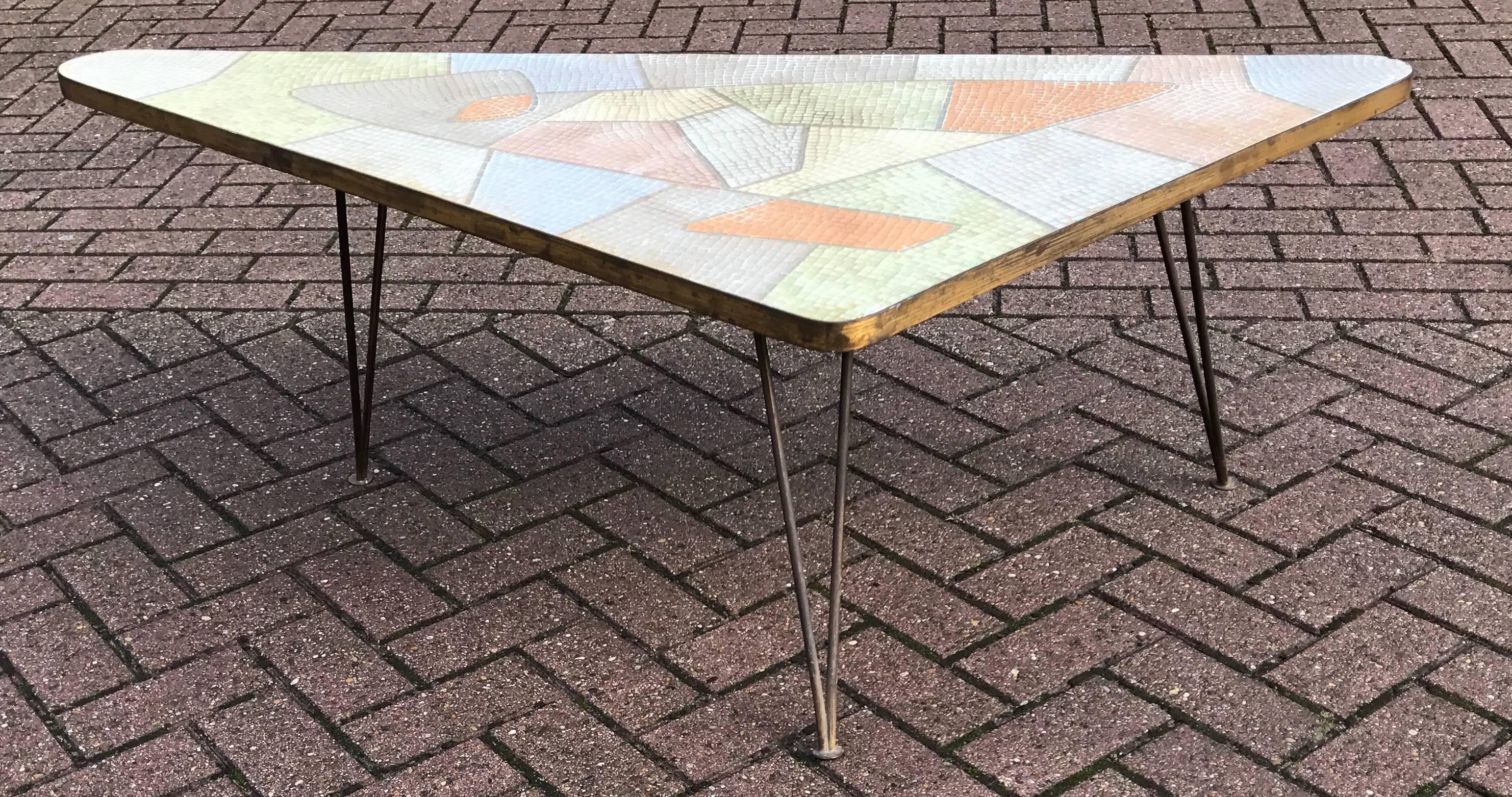 Stunning and all handcrafted 1950s mosaic inlaid table attributed to Berthold Müller.

We attribute this mosaic triangle tripod coffee table to German sculptor Berthold Müller of Oerlinghausen (1893-1979). The table has a fantastic, organic shaped