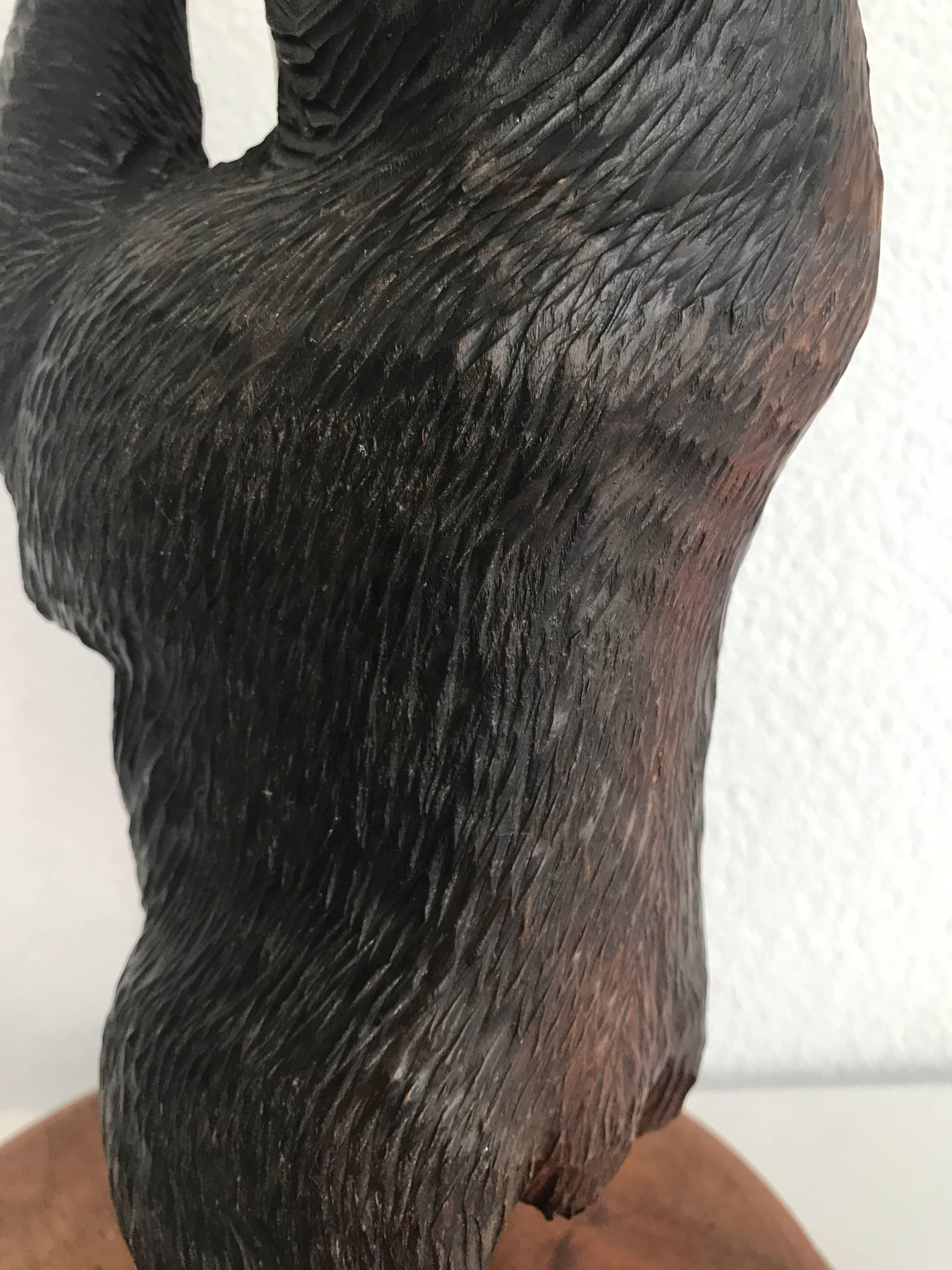 Beautiful quality and perfect condition bear lamp. 

This Black Forest bear is carved in a beautiful pose. In this rare table lamp sculpture he is holding up a ball, which is the base for the light socket and shade. It is handcrafted antiques like