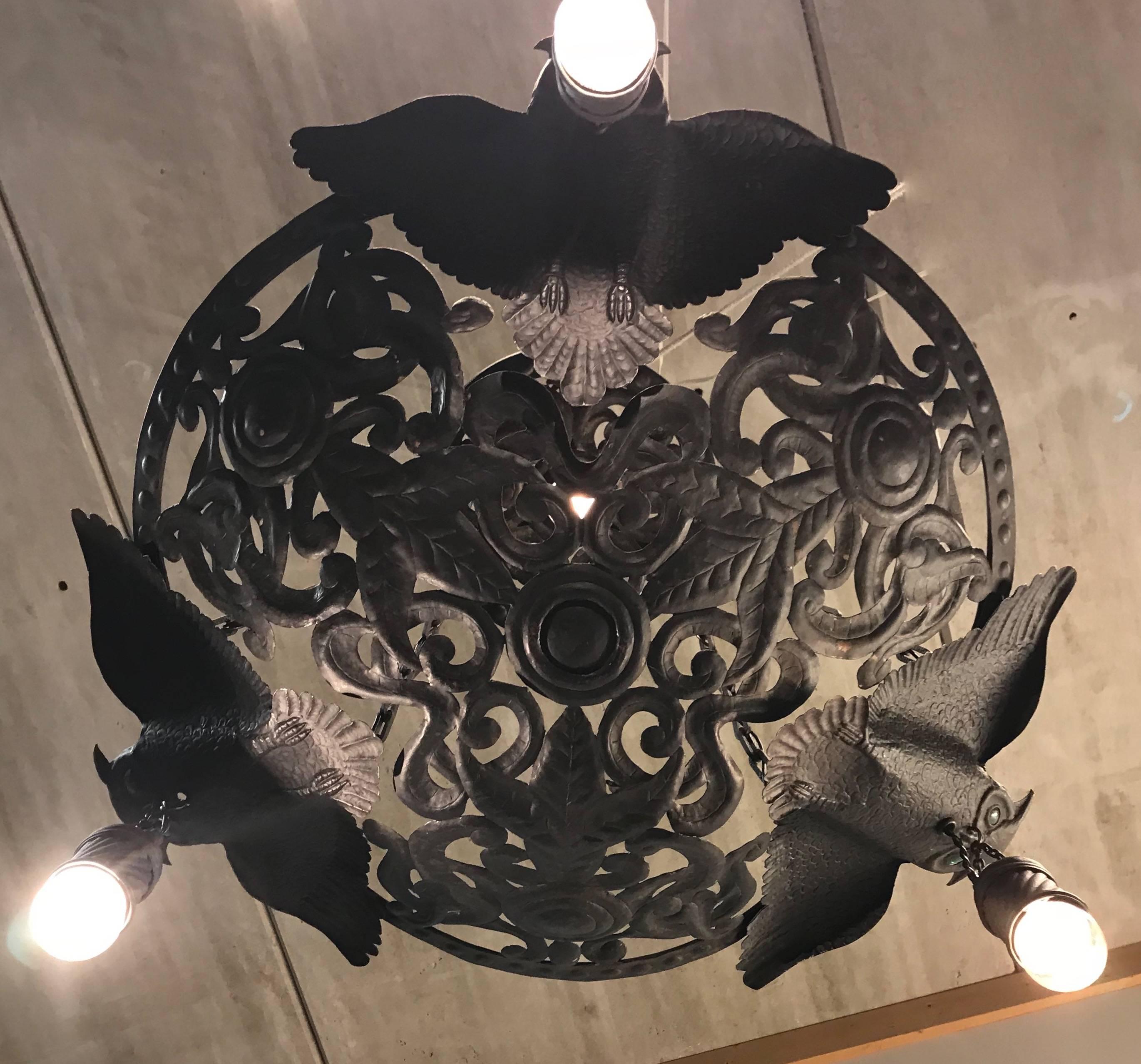 Early 20th century, owls with glass eyes chandelier. 

If you are a collector of unique and stylish, Arts & Crafts antiques then this amazing and all handcrafted light fixture could be perfect for you. The broad winged owls in this pendant, look