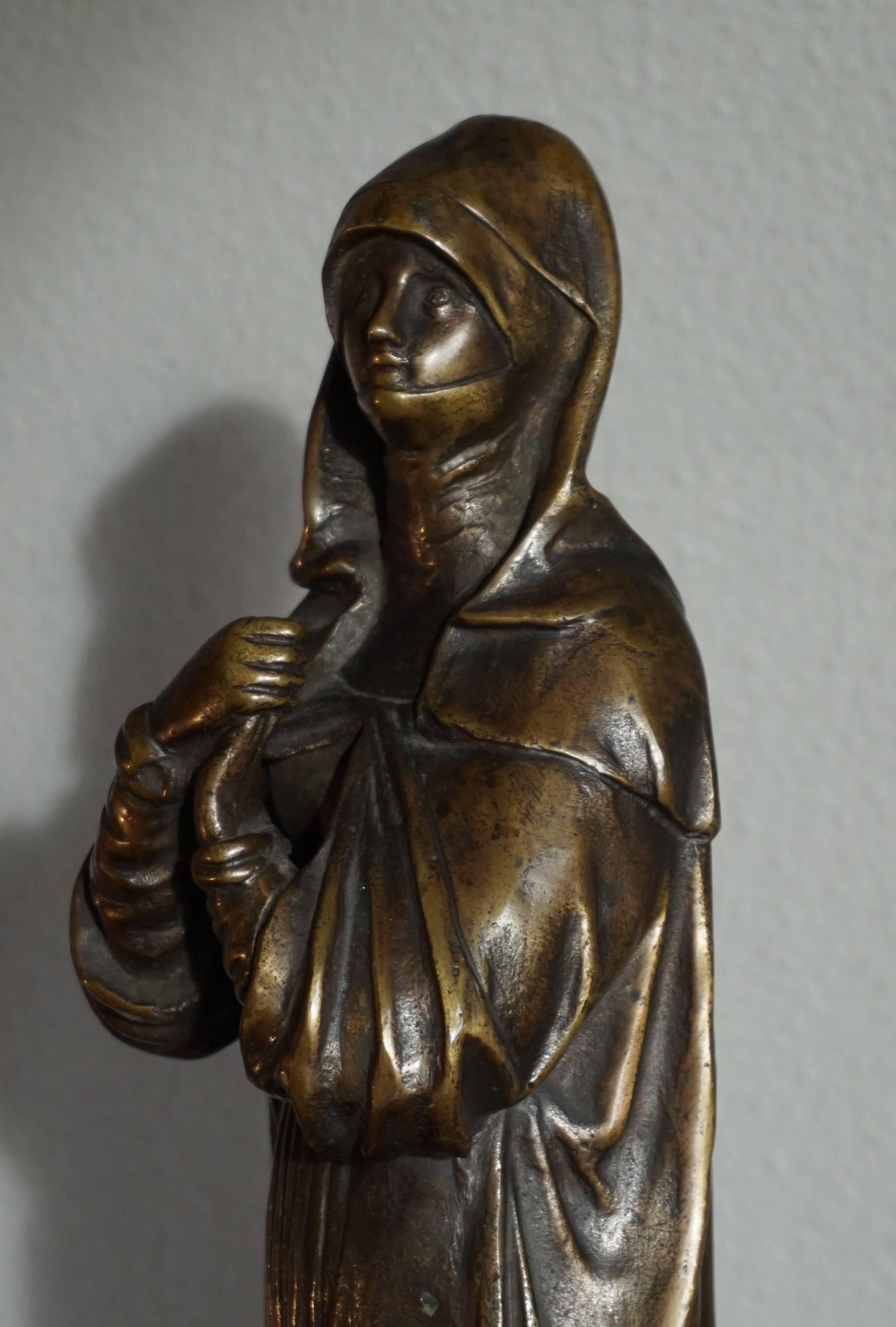 Religious work of art in beautiful bronze.

This religious work of art depicts a Saint Teresa (1515-1582) in a most devout stance. Teresa was a Spanish mystic, writer and reformer of the Carmelite order. She was an influential and pivotal figure of