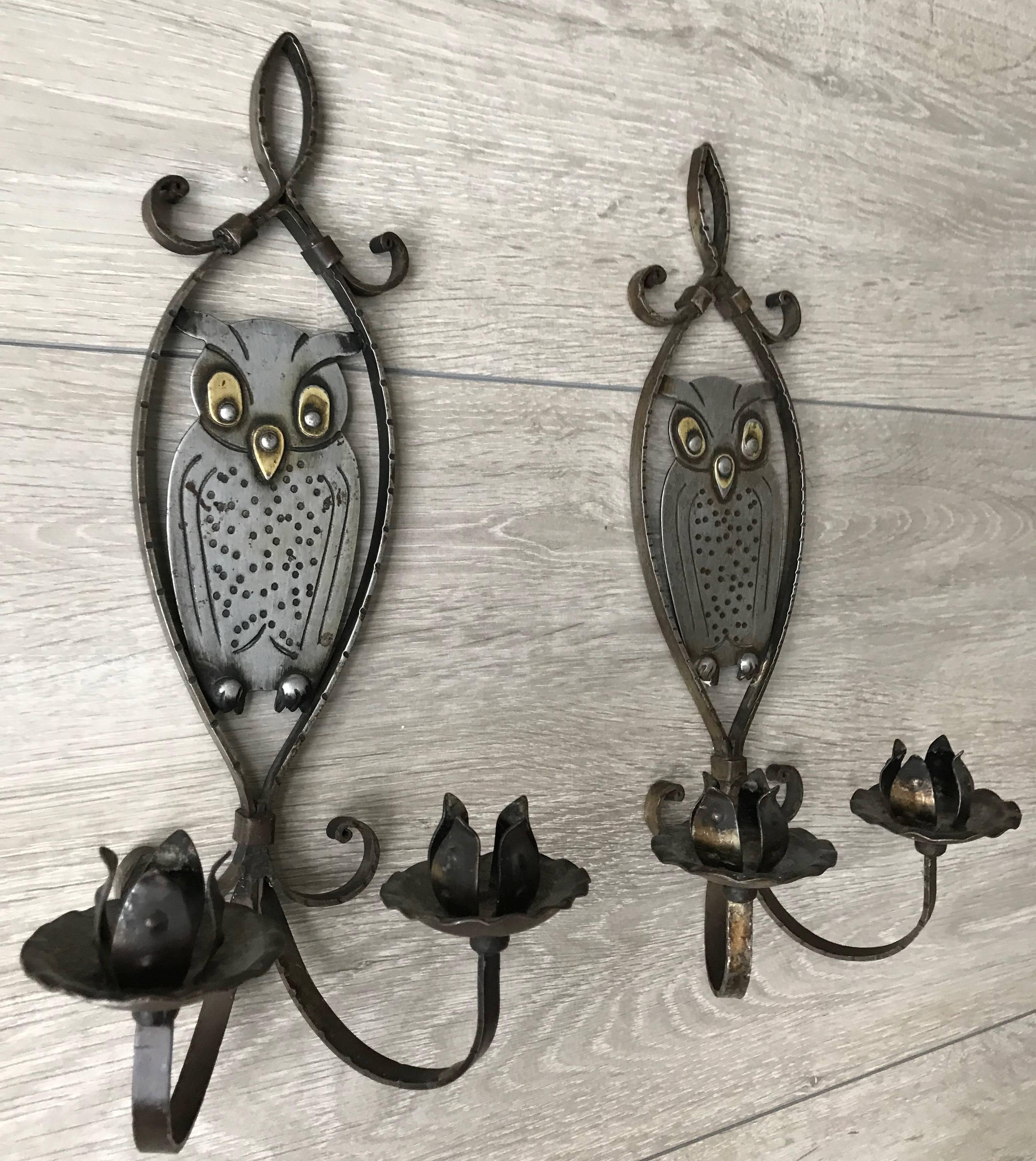 Lovely pair of hand-forged and hand-hammered iron wall sconces by Hugo bergere.

This rare and all handcrafted pair of candleholders is in very good condition and they are both marked Goberg. The owl as the international symbol for learning and