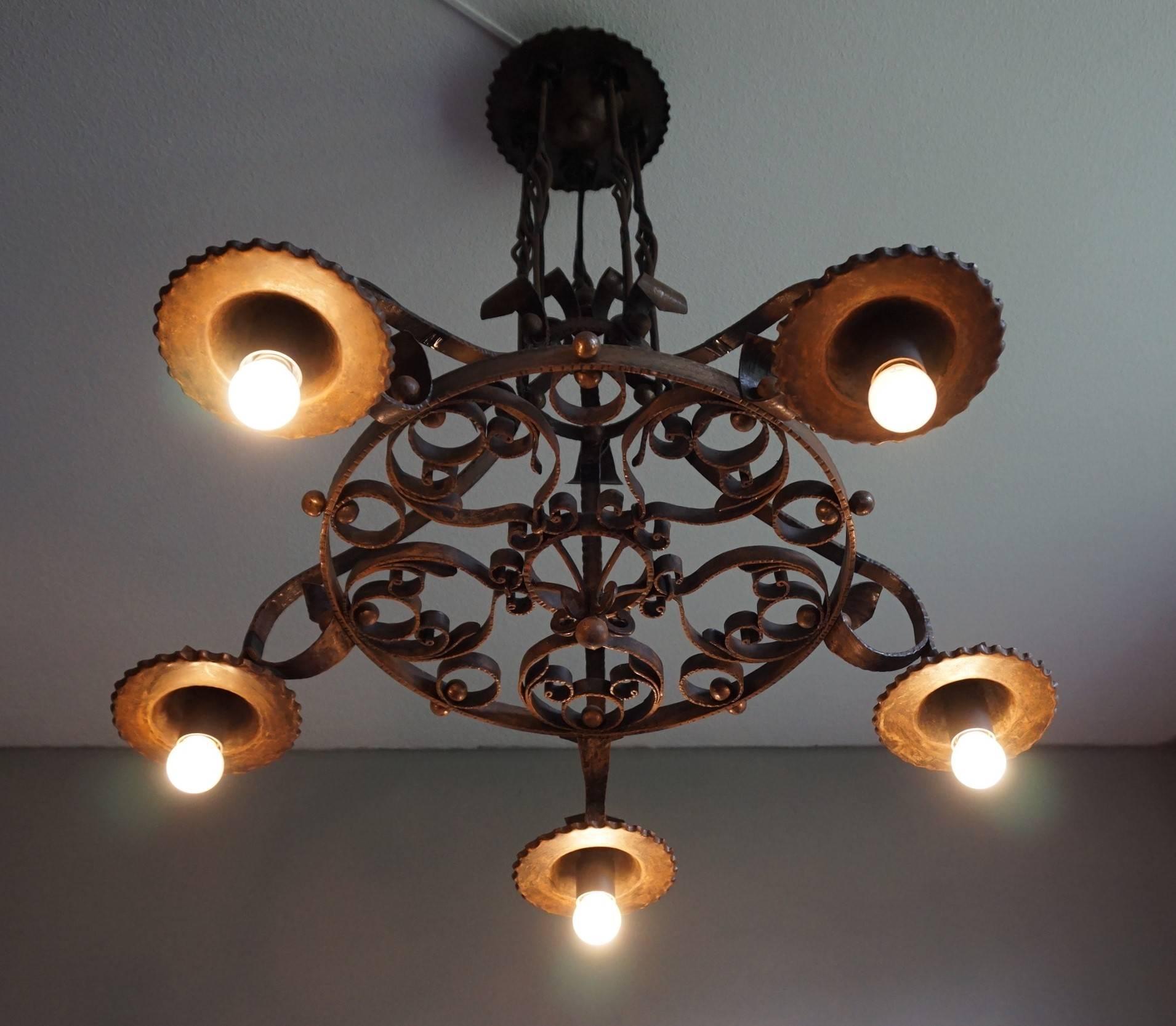All hand-crafted, early 20th century Arts & Crafts pendant.

If you are looking for a rare and impressive Arts & Crafts pendant to light up a large entrance or to hang above your dining table then this forged in fire chandelier could be perfect