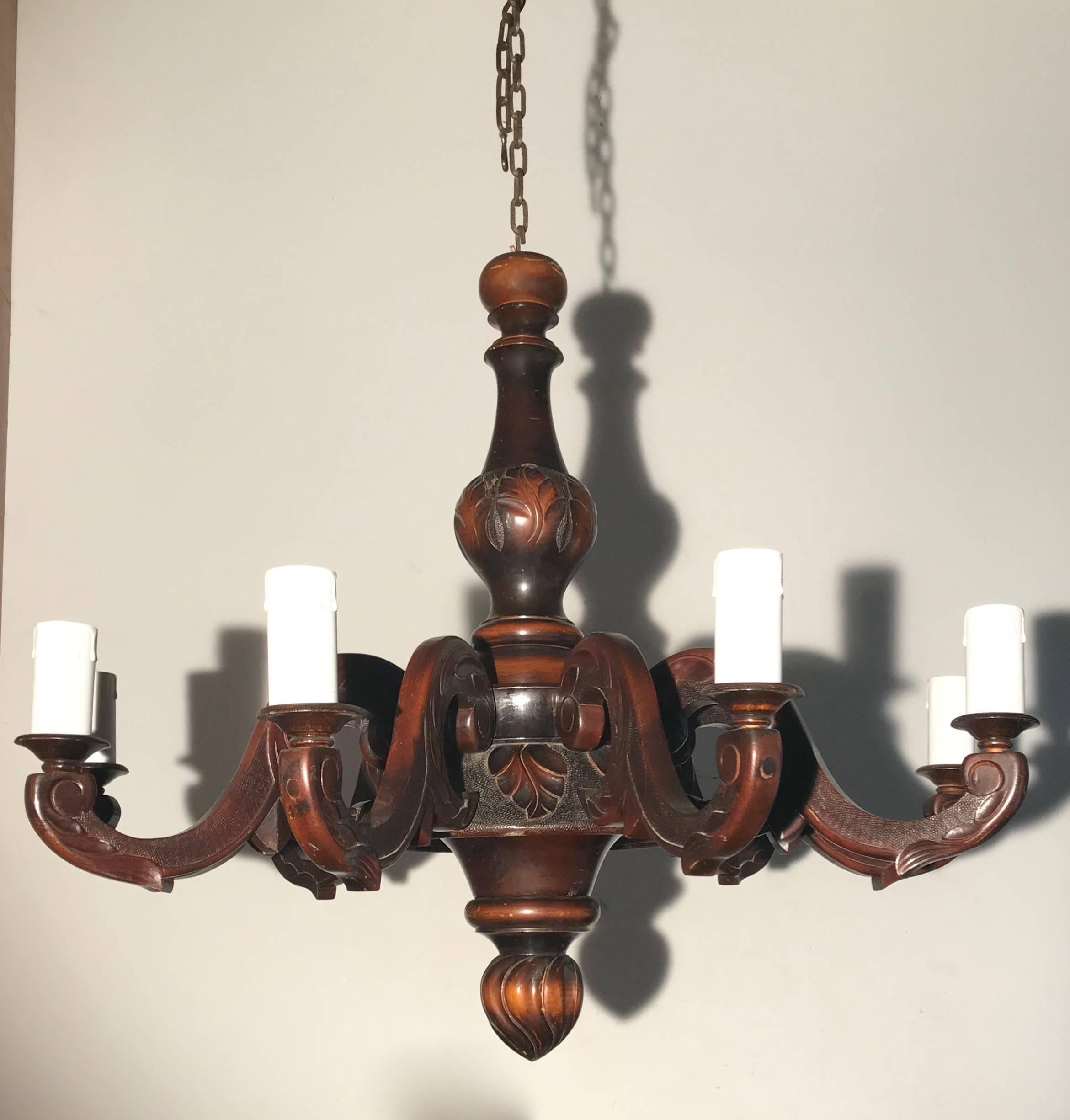 Handsome and well carved nine-light chandelier, from circa 1915.

If you are looking for a sizeable, classical wooden chandelier with a warm look and feel to create just the right atmosphere in your dining room then this could be the one for you.