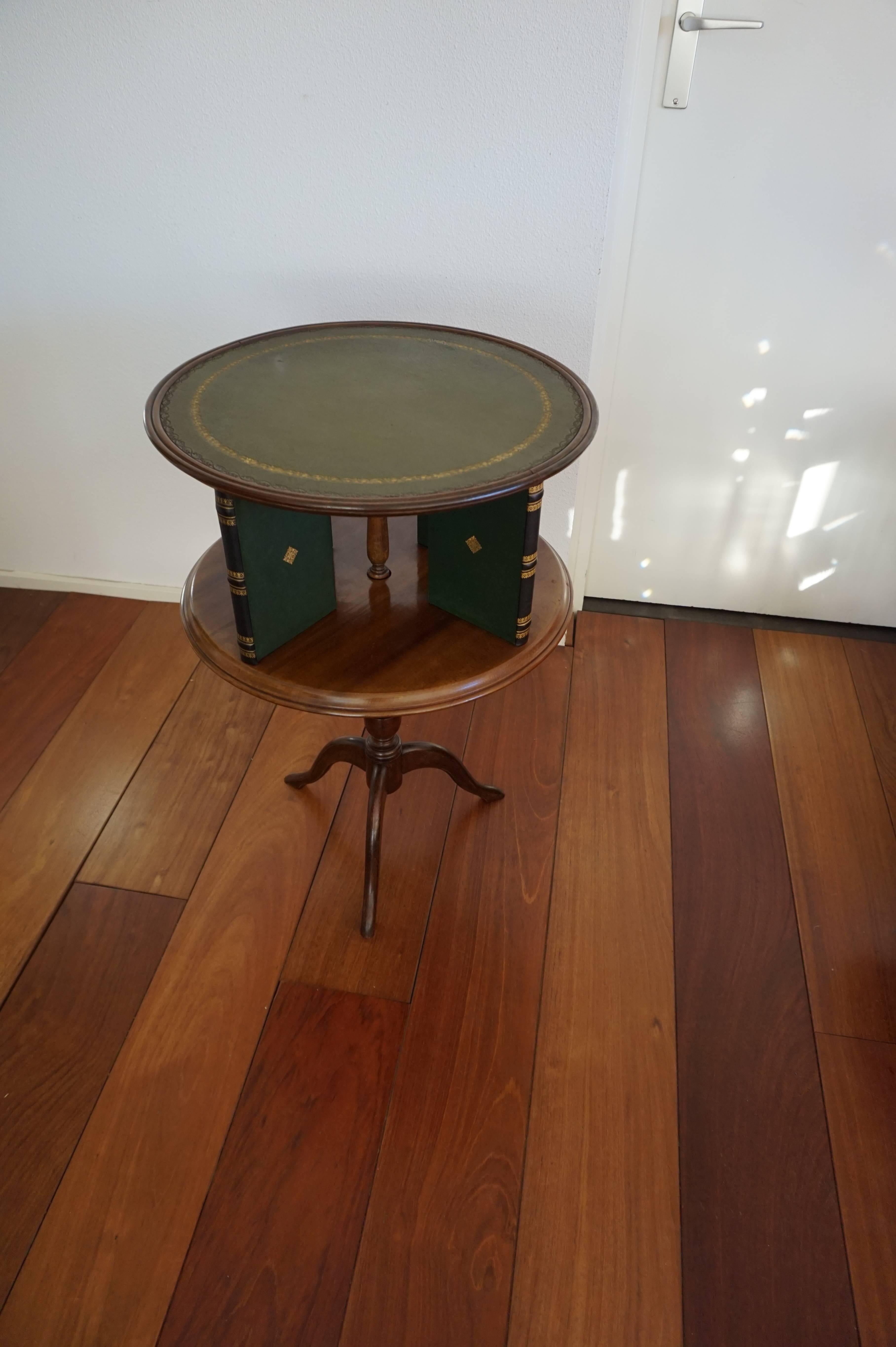 Stylish and practical books table with inlaid leather top.

This rare shape and highly stylish table is both a revolving bookcase and an occasional table. It can be used as a revolving bookcase with only a vase or a lamp on top, but one could also