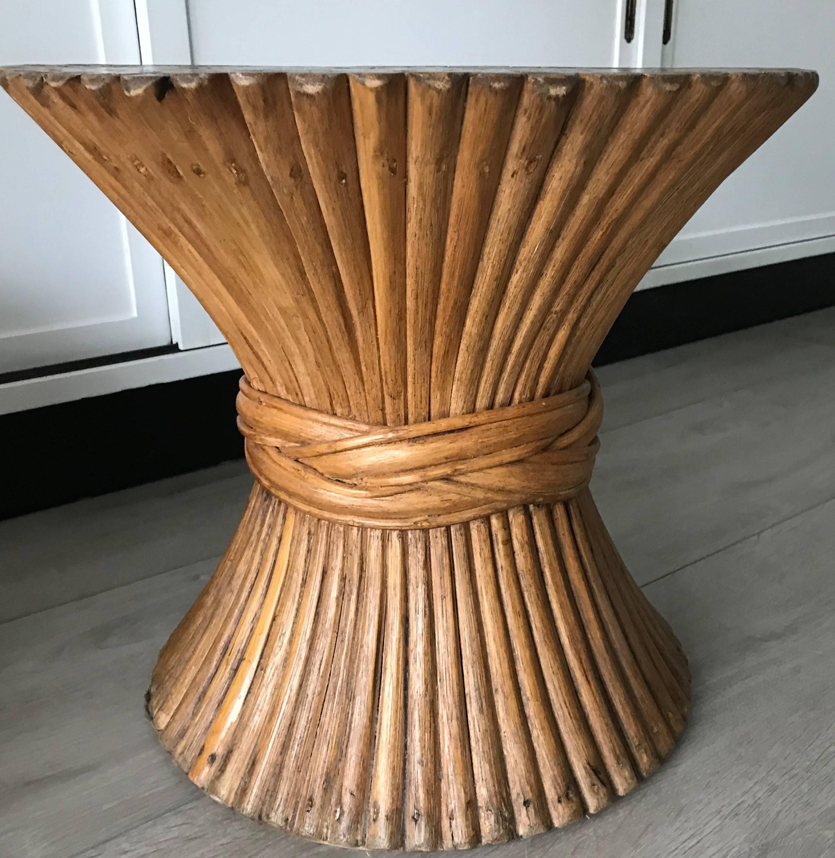 1960s McGuire shaped, sturdy wooden table. 

This decorative and organically stylish table has been cinched into a sheaf of wheat. The wooden shafts are stylishly encircled by a decorative rattan tie. This handcrafted, American piece of furniture