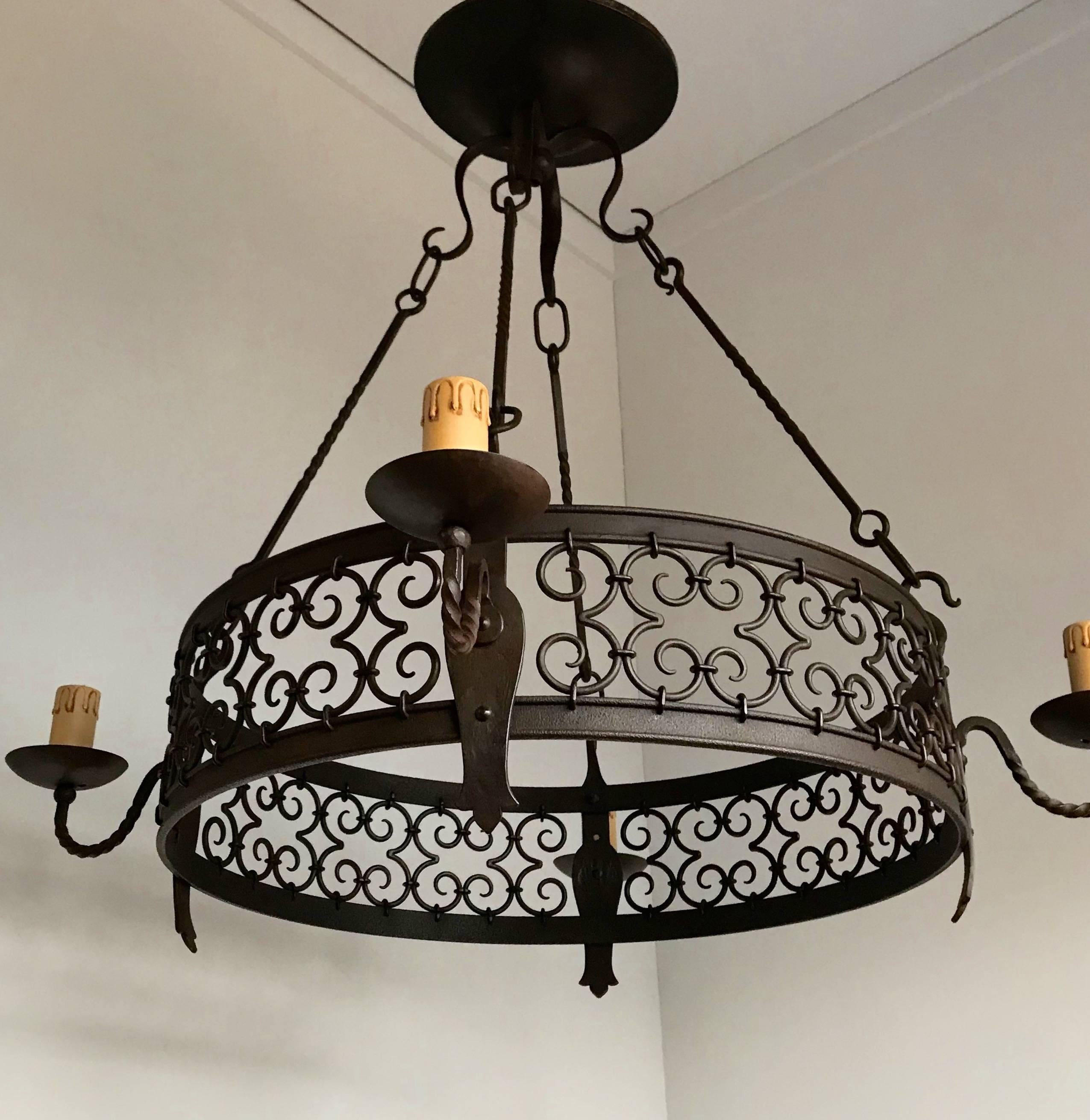 Quality crafted, forged in fire four light chandelier.

This good quality, hand-forged wrought iron chandelier comes with beautiful and artistic details which certainly lifts it above the average. In the right space it will look the business and we