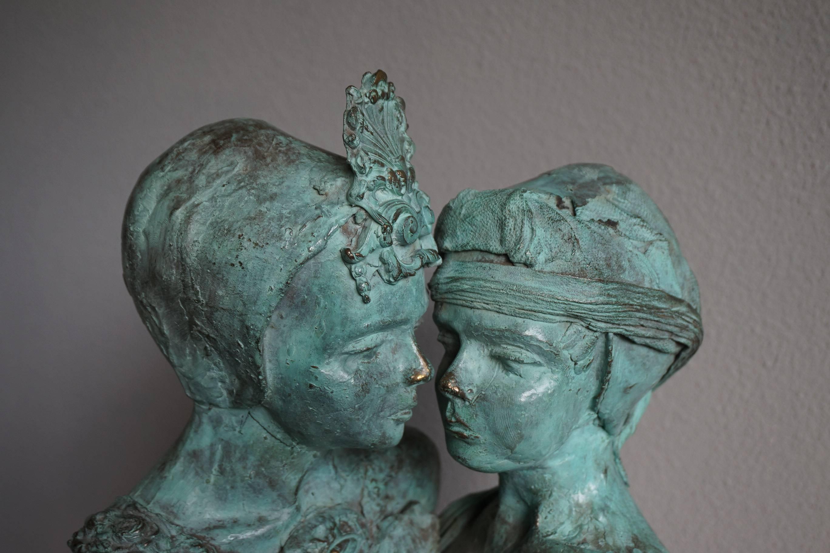 Sensitive and touching double-bust sculpture.

We don't know about the relationship between these two women, but the artist clearly shows us that it is a very intimate one. By placing these serene and silent female faces close to one another, the