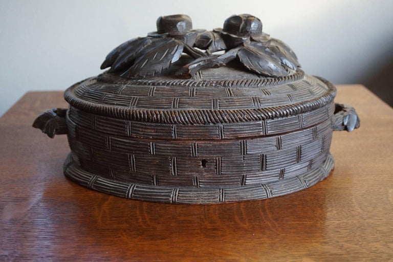 Antique hand-carved box with roses on top.

This rare Black Forest box from circa 1870-1880 has the most beautiful design and details and it can be used for all kinds of purposes. The oval shaped ratan basket comes with floral design handles. On top