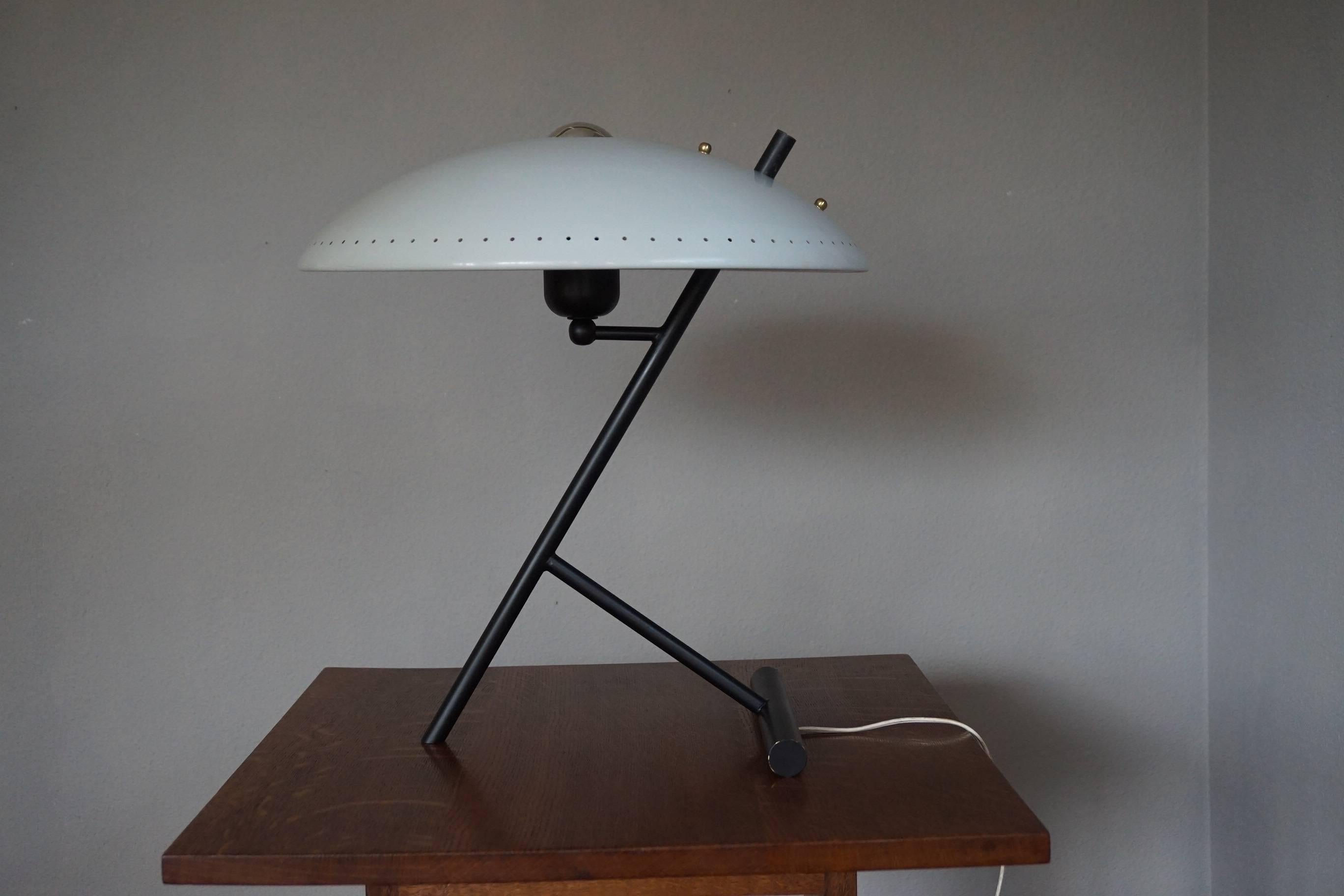 Timeless and stylish table lamp.

This wonderful midcentury table lamp by Louis Kalff is in beautiful condition. This color combination will look great in virtually every mid-century interior and this lamp is an absolute joy to look at, both on and