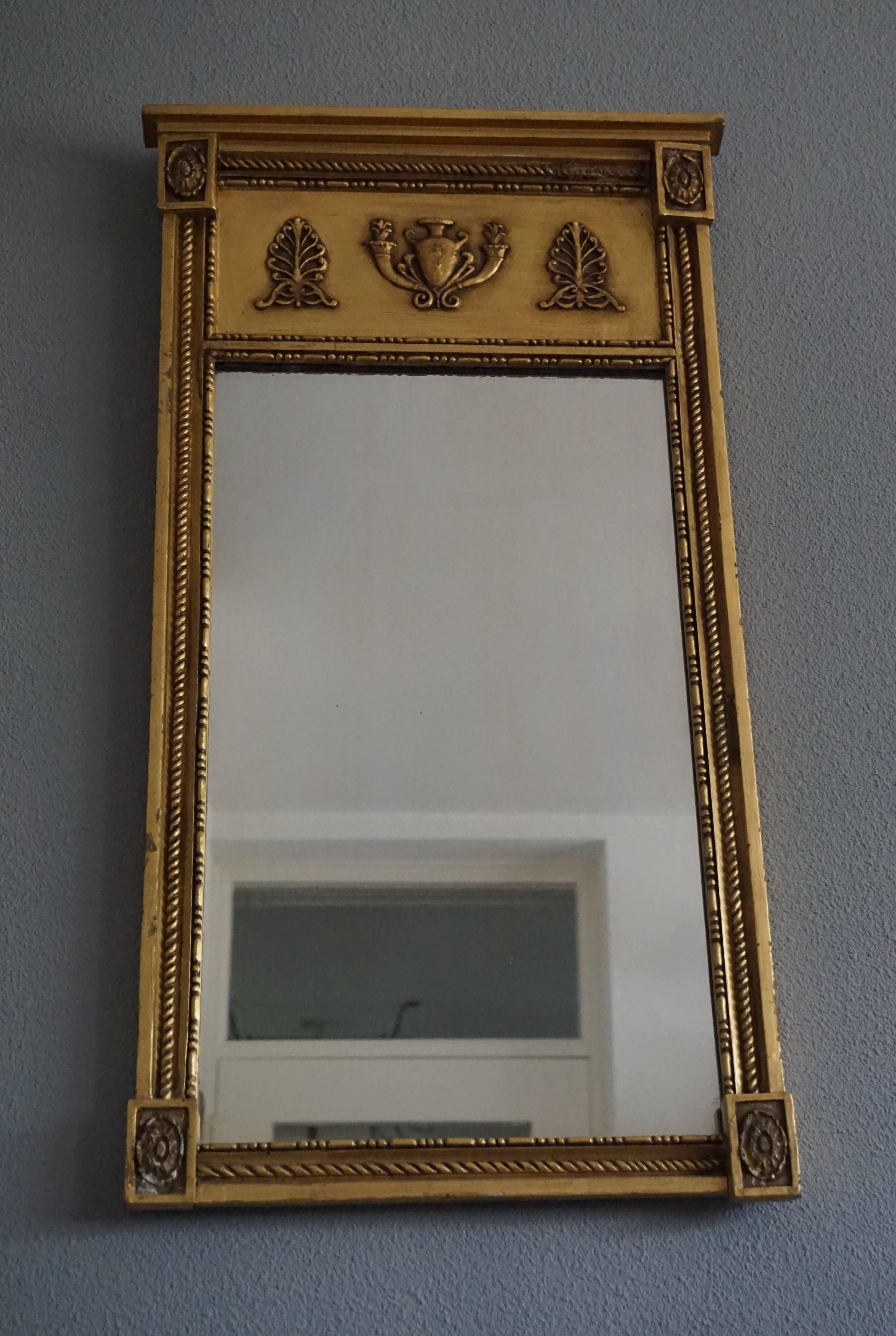 Handcrafted and stylish antique mirror.

This 150+ year old mirror too can be a wonderful addition to a marvelous, stylish and classical interior. This Southern European, gilt wall mirror comes with fine Empire Style elements in relief. Apart from