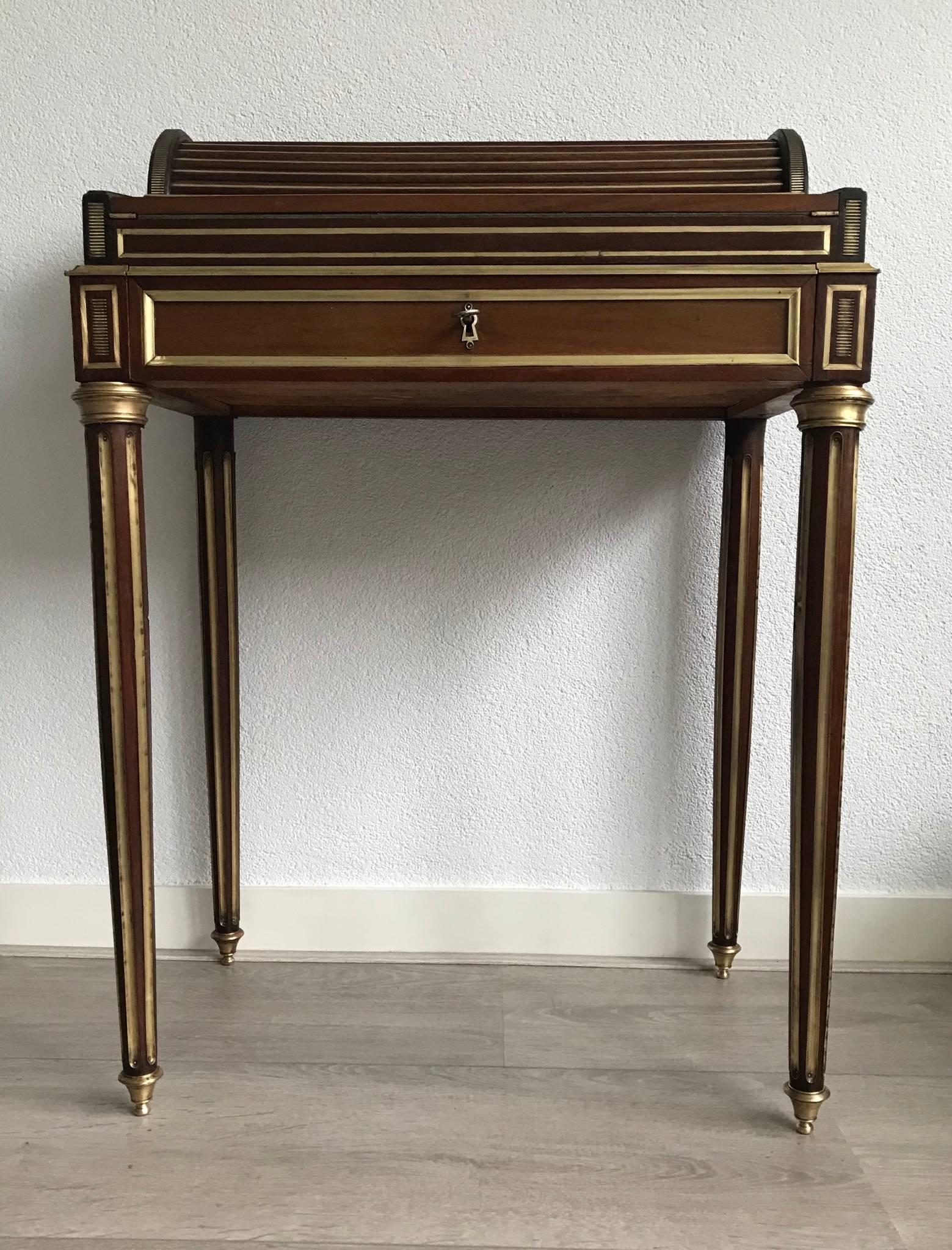 Fine quality and stunning design Louis XVI style desk.

This wonderful antique ladies desk is supported by four elegant legs and turned brass feet. The over-all design and also the combination of the top quality mahogany and the stunning brass style