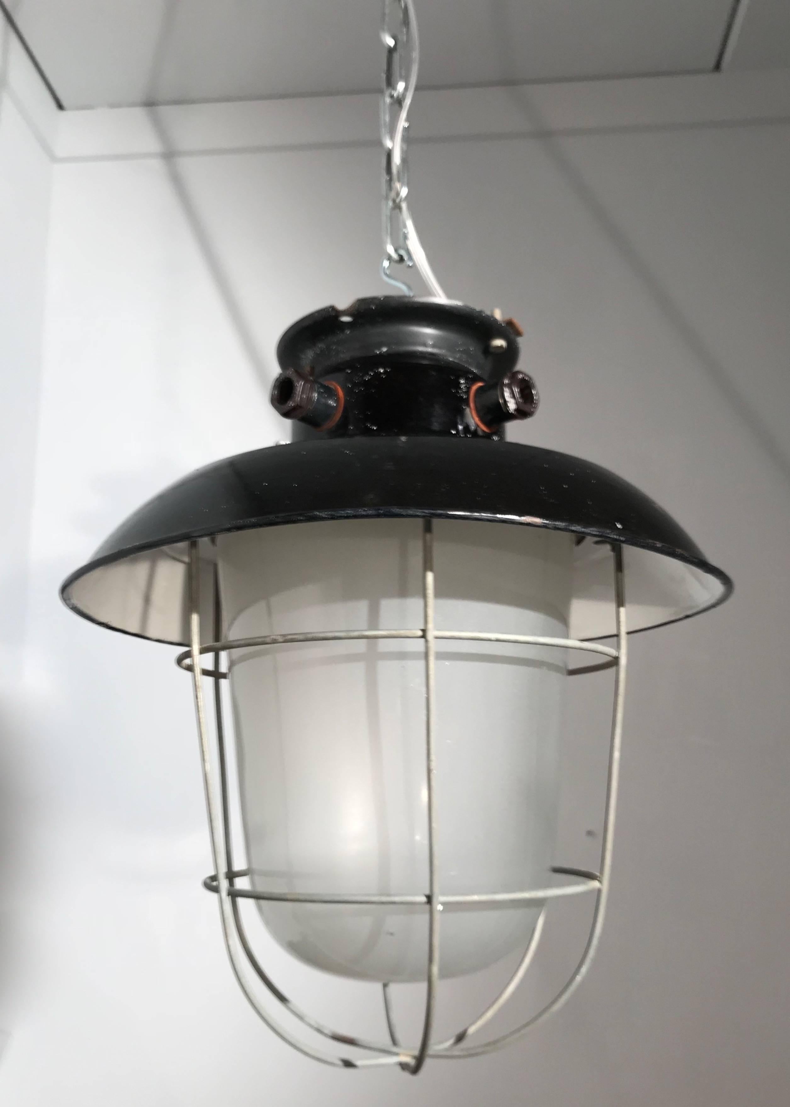 European 1920s Matching Pair of Industrial, Glass & Black Enamel Caged Light Pendant For Sale