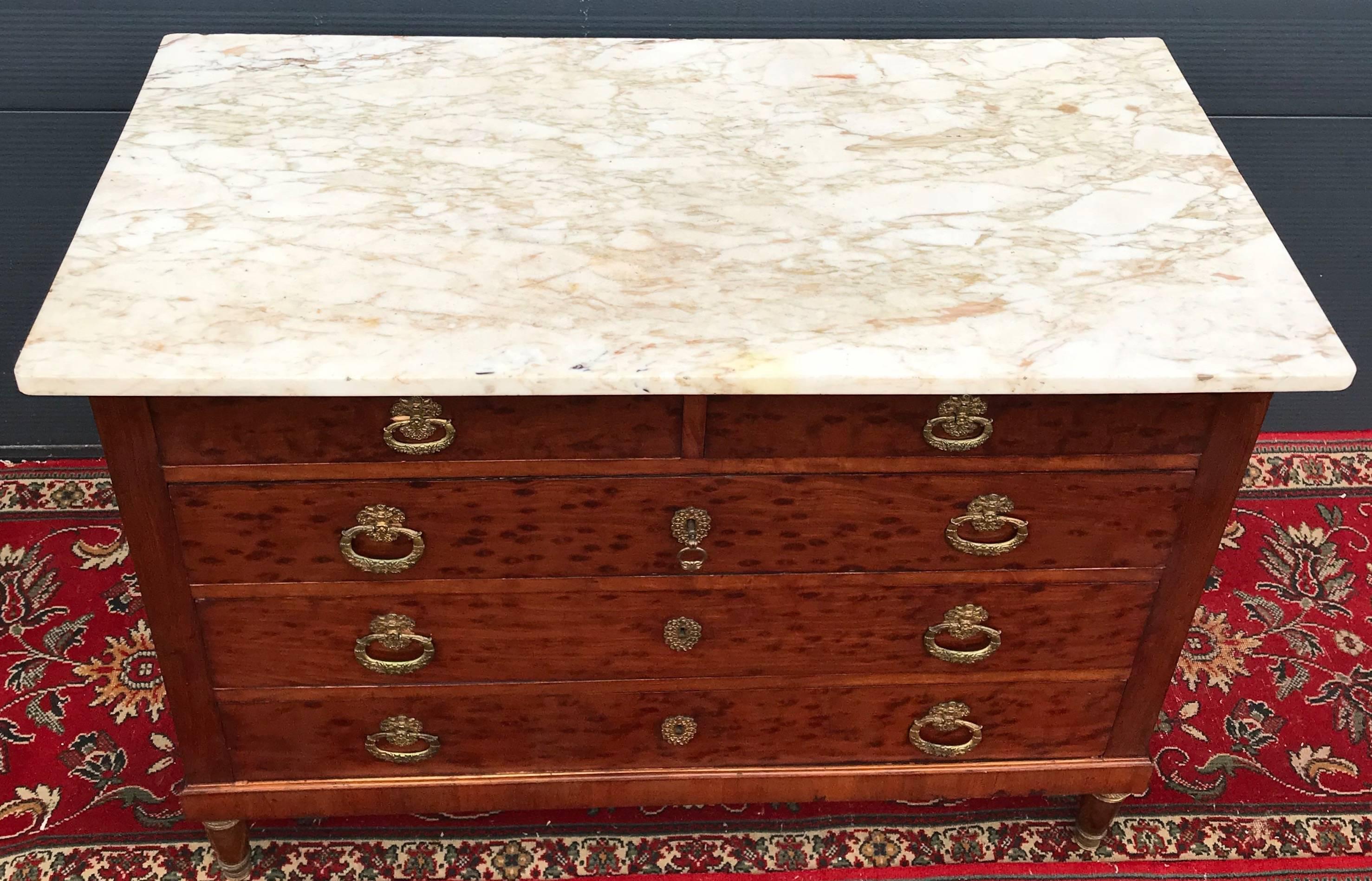 Rare and spectacular, late 19th century chest of drawers. 

This beautiful Empire style commode has obviously been used, but the condition is good to excellent. It has a beautifu warm color, but we have never seen this exotic wood ( burl/burr )with