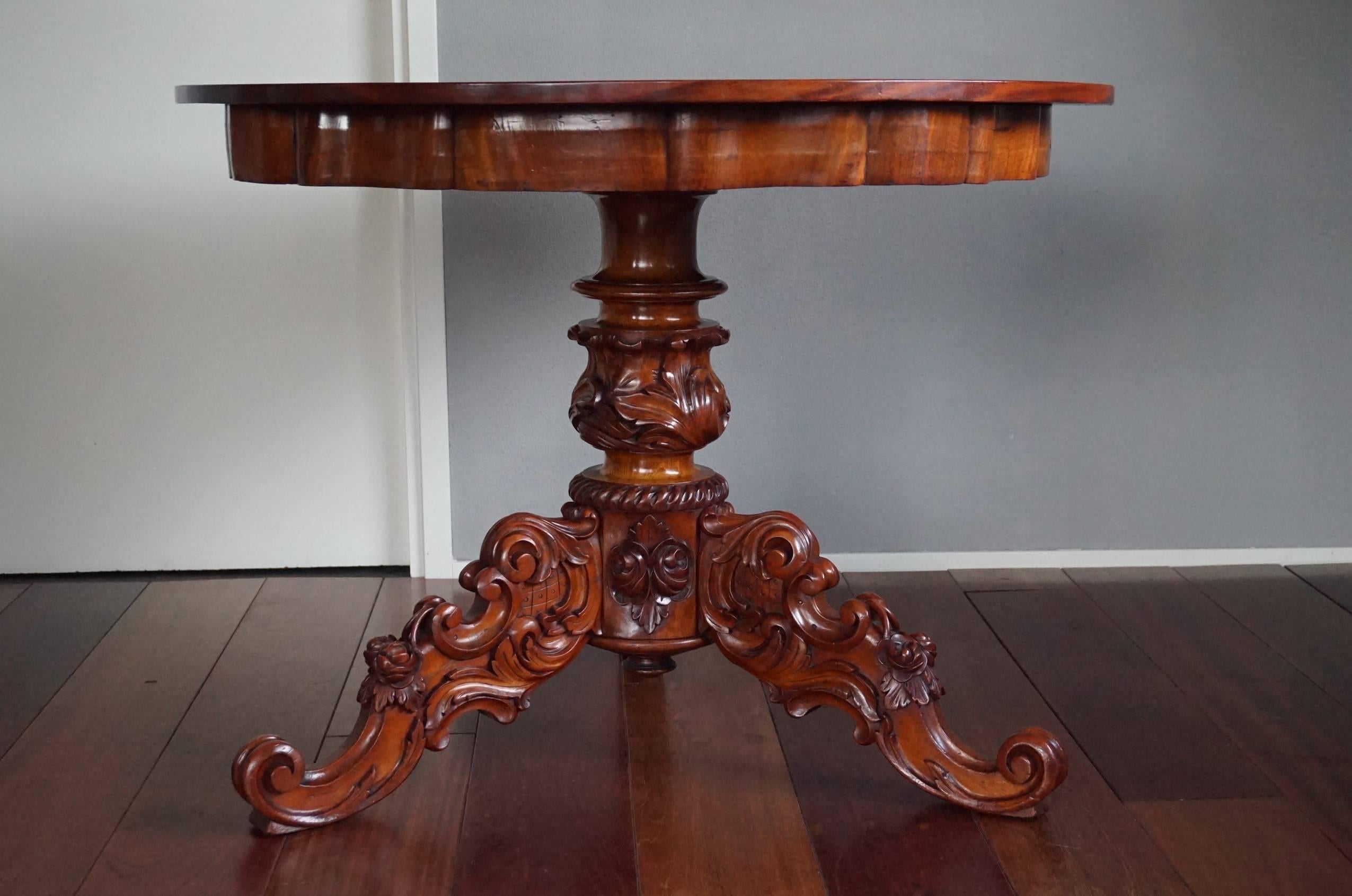 Impressive antique dining table.

This striking, mid 1800s two-piece dining or center table is of a beautiful shape and color. The hand-carved, solid wooden base with the wonderful, scrolling leafs is of the finest quality and condition. This