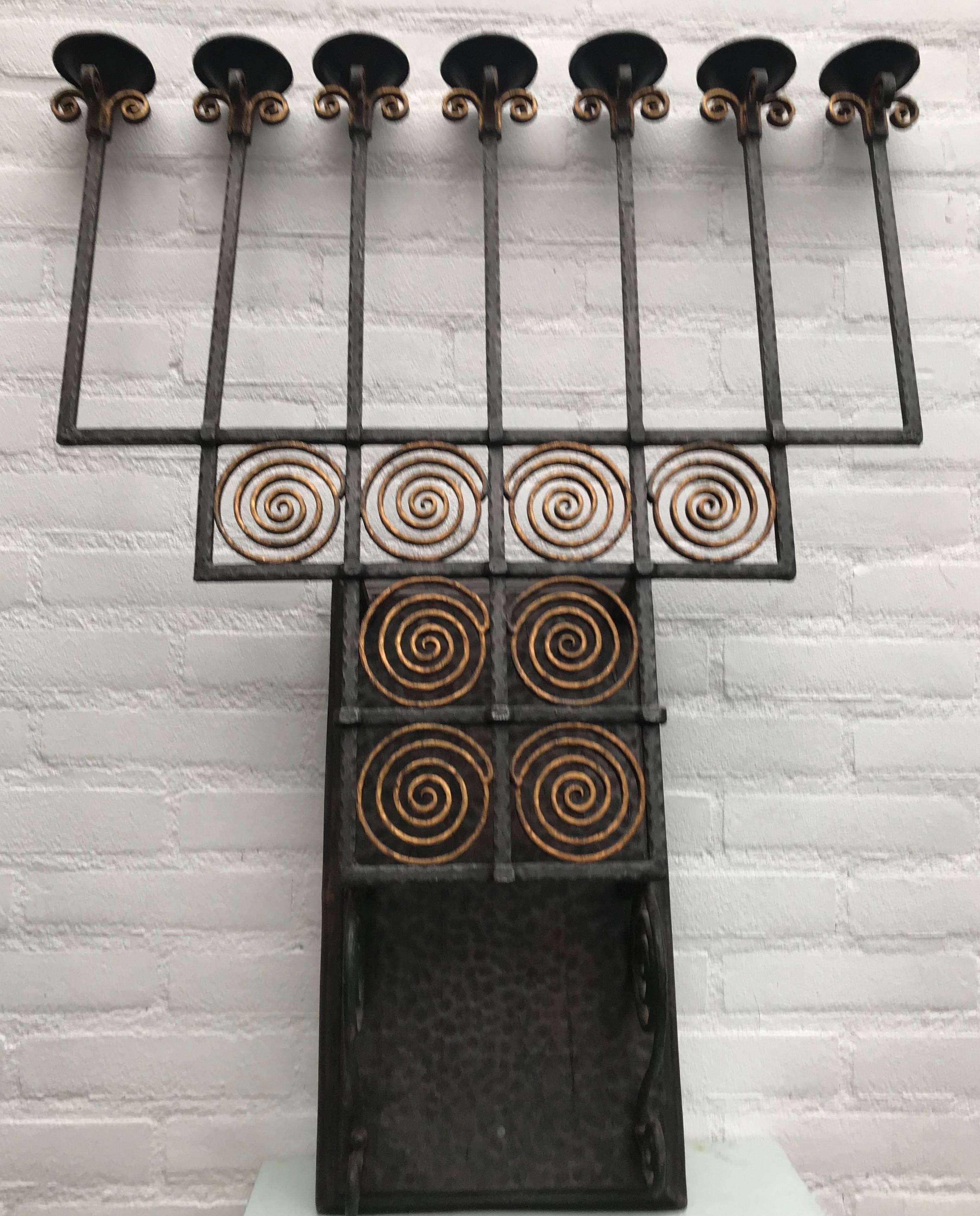 Stunning Arts & Crafts hand-forged sconce.

This turn of the century wall sconce is incredibly well made, easthetically very pleasing and easy to mount on your wall. This forged in fire work of wall art and candelabra in one is of such a timeless