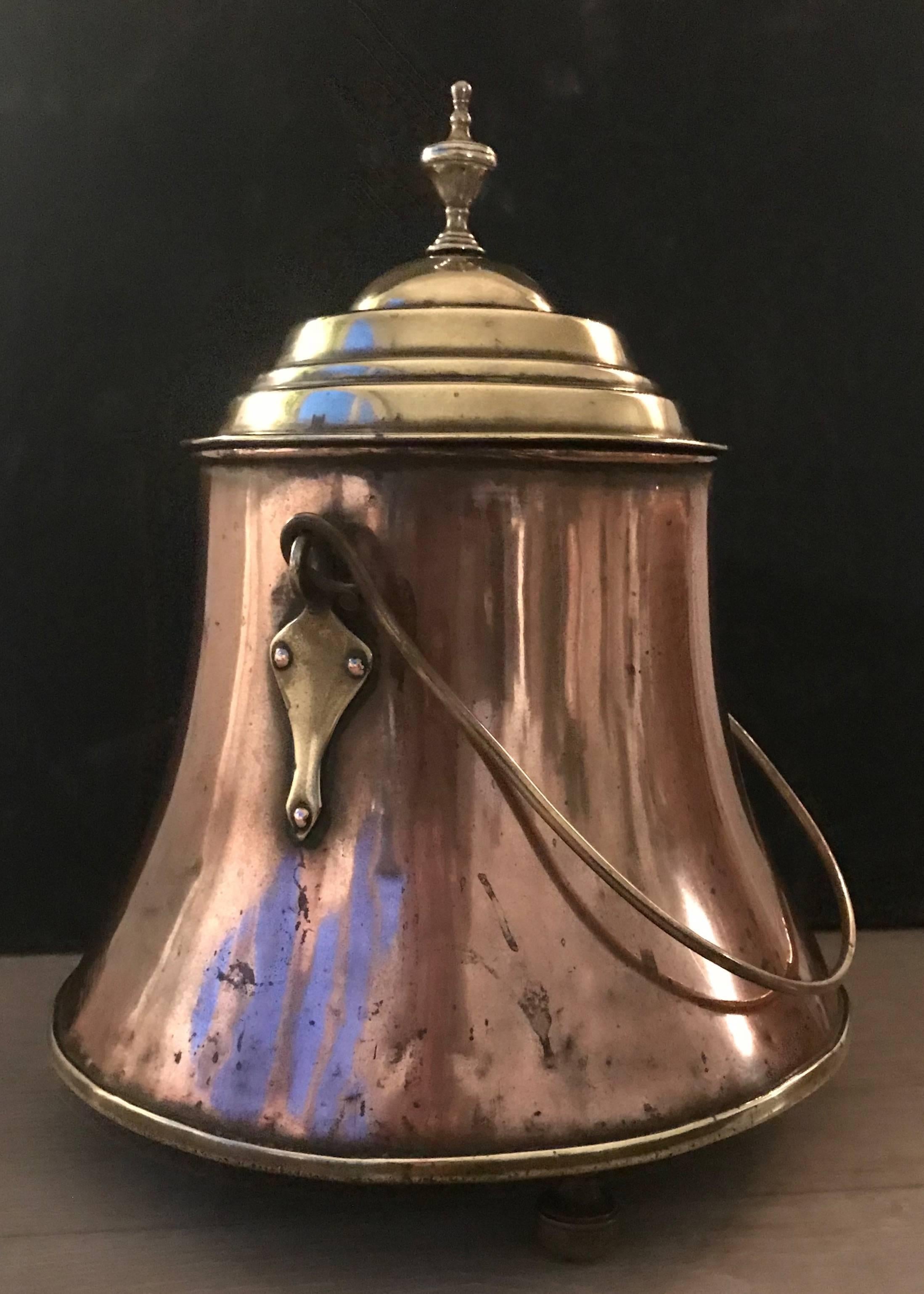 An elegant and very decorative, early 1800's copper fire place tool.

This hand-crafted, copper and brass kettle could only be afforded by the very well-to-do in the 1800's in Europe and in the  Netherlands in particular. It would have taken a