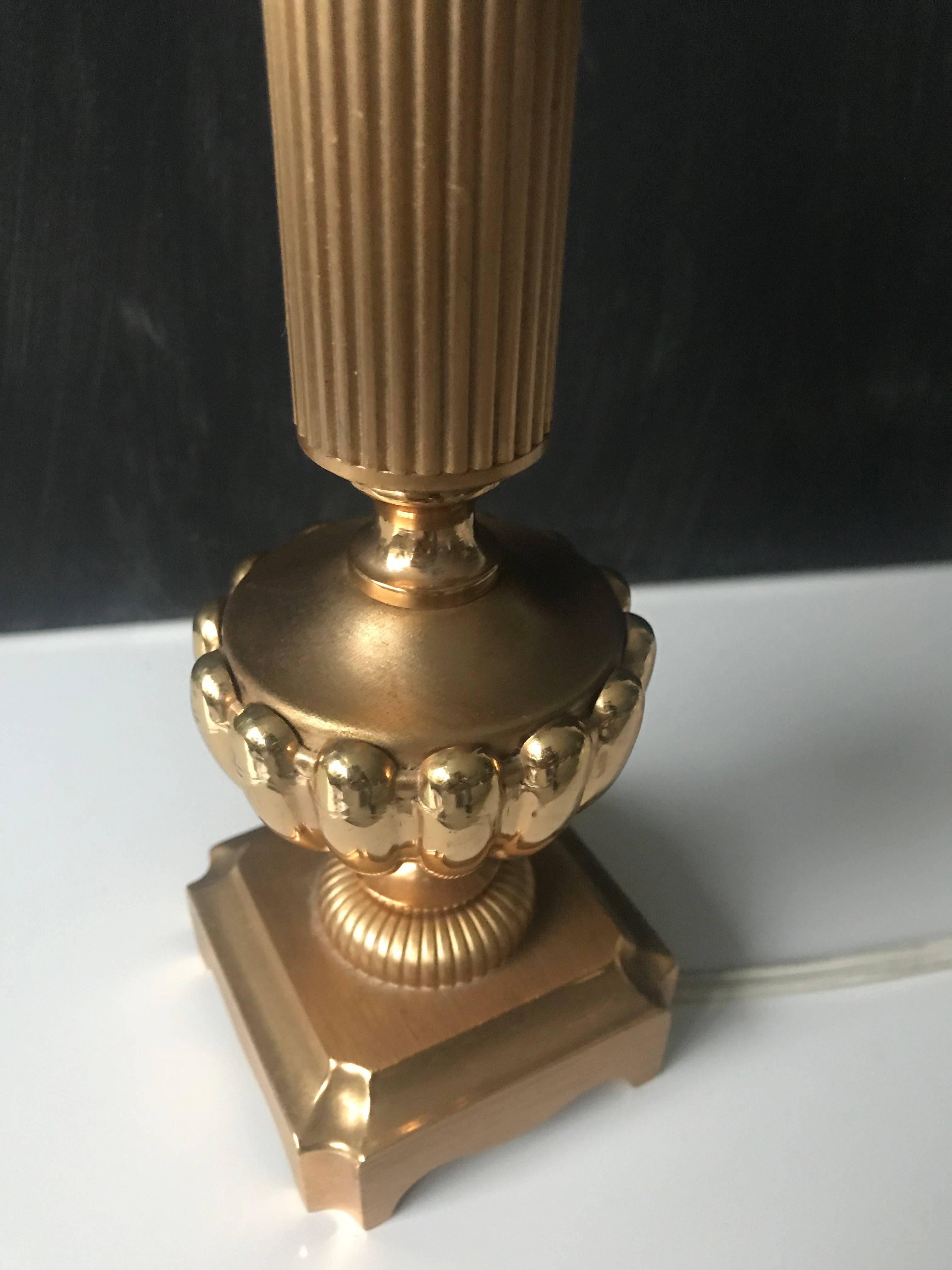 Lovely small-size and perfectly gilt, bronze table lamp.

This elegant and stunning little lamp in the Hollywood Regency style is in excellent condition. This finest of lamps is marked at the bottom, Sciolari Mod. 543 and it will look marvelous, no
