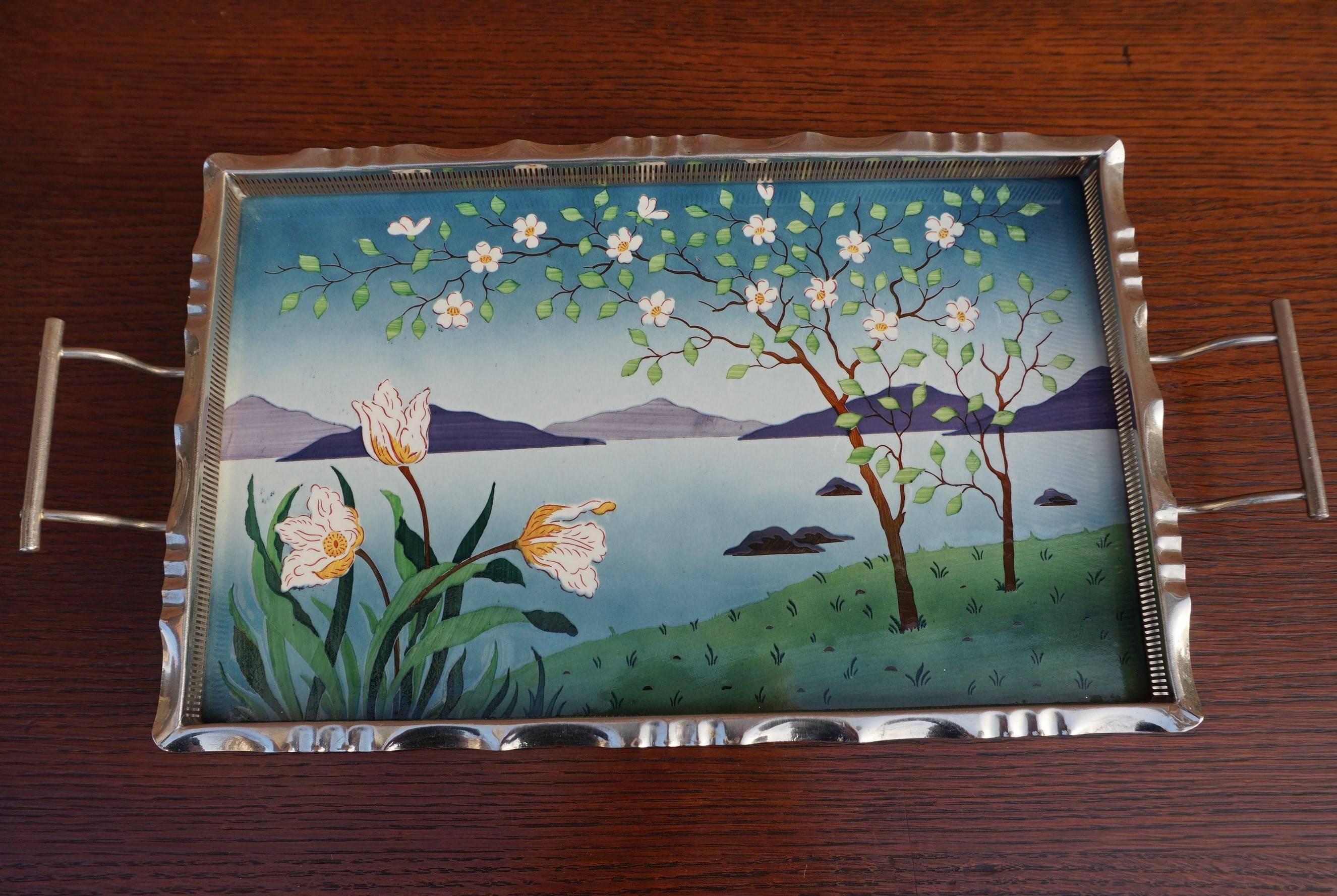 Rare Arts and Crafts tray with stunning and serene landscape.

The beauty of early 20th century Arts and Crafts home accessories is that they are almost always works of art in their own right. These antiques were not made hastily, they were not made