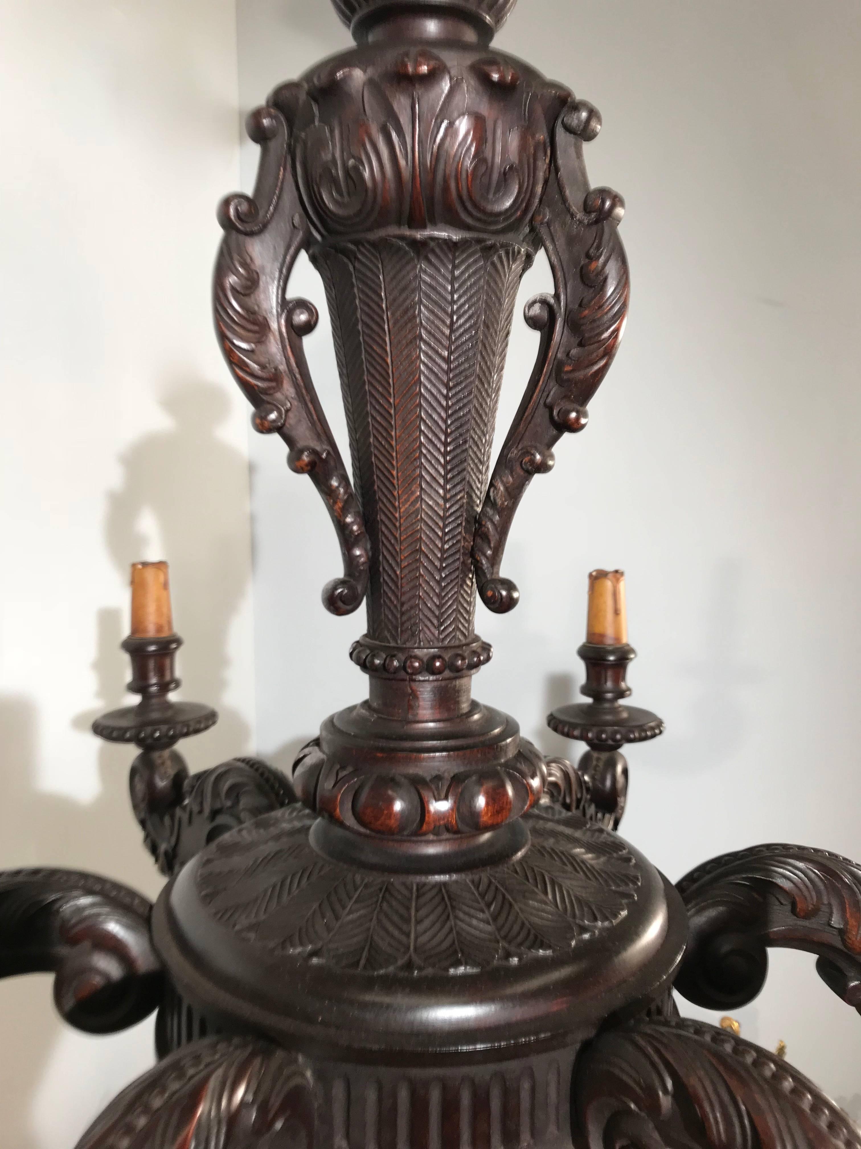Stylish and all handcrafted chandelier from the turn of the century.  

This antique and beautiful quality pendant of a hundred years old has six perfectly and evenly, hand-carved arms. This stylish example of turn of the century workmanship is made