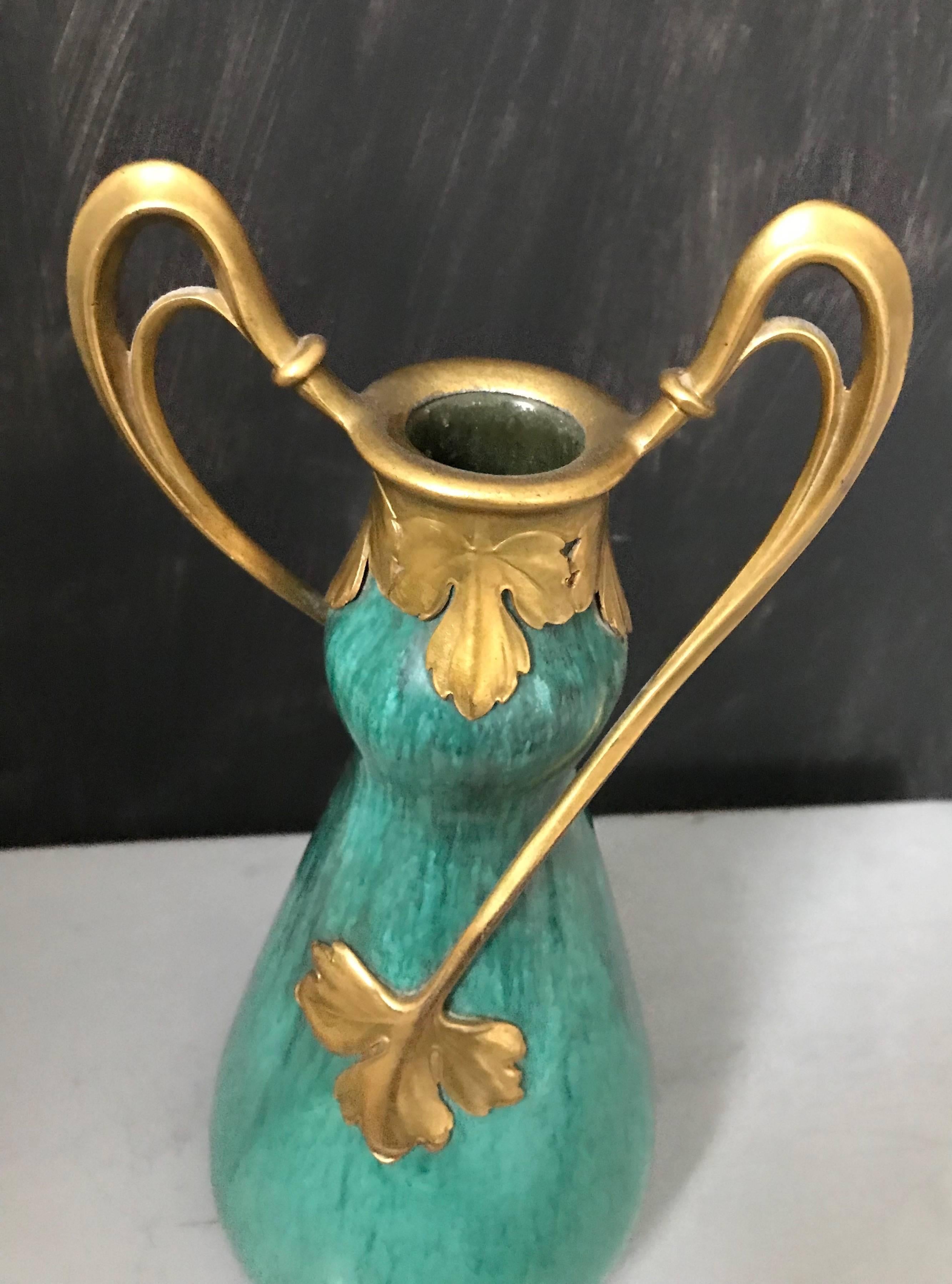 Top condition and pure elegance Art Nouveau vase.

For the collectors of museum quality and condition Art Nouveau ceramics. This stunning Art Nouveau vase is decorated with the most beautifully flowing and symmetrical, bronze arms. There are only