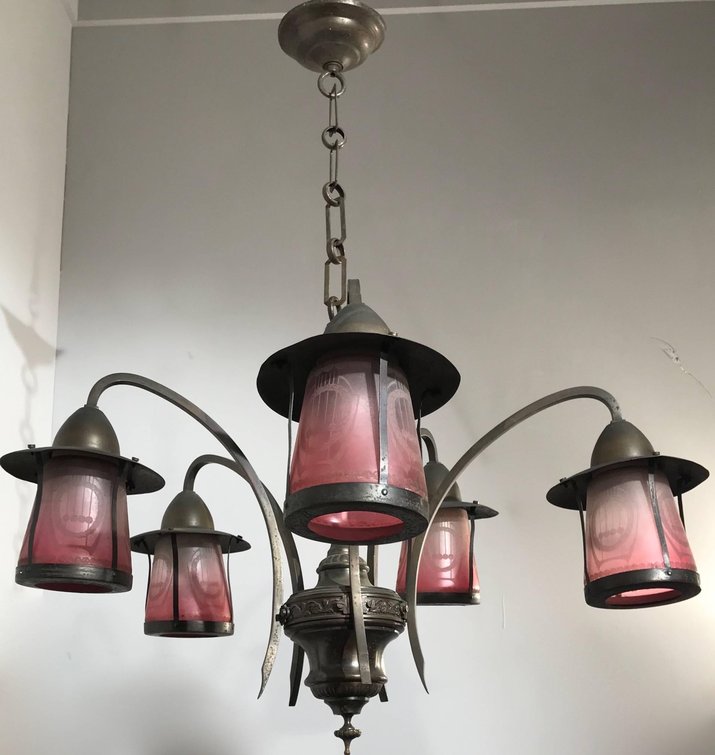 Beautiful and rare Arts & Crafts chandelier.

This light fixture from the heydays of the Arts and Crafts period comes with the original glass shades. These wonderfully colored shades come with highly stylish, accid etched motifs. Unfortunately we