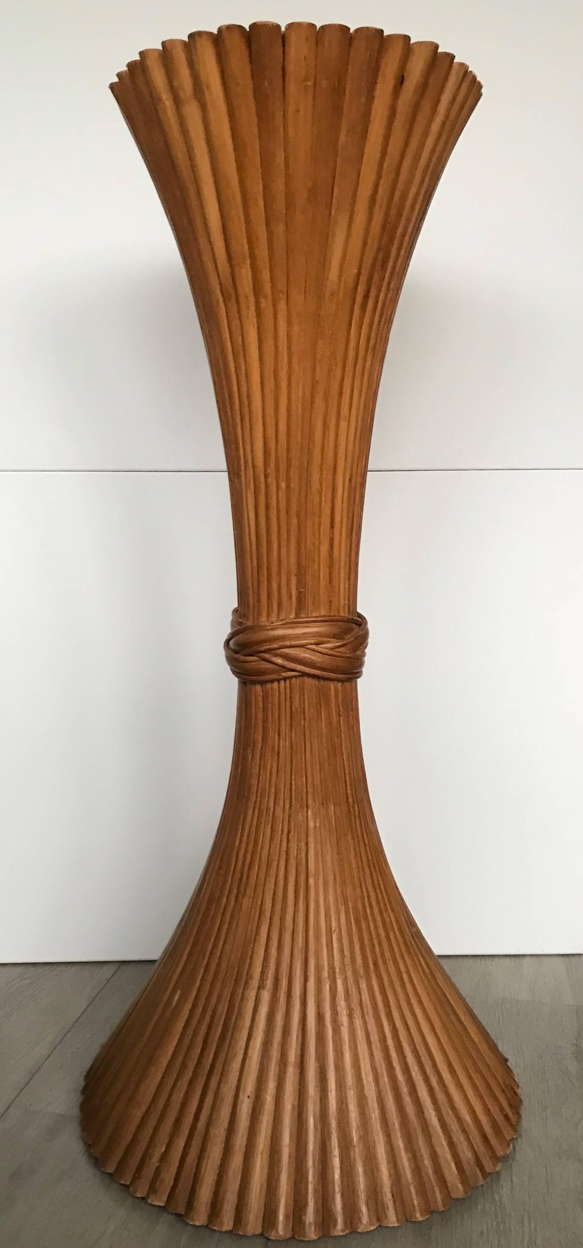 Stunning and sturdy, hourglass shaped, wooden McGuire stand. 

This decorative and organically stylish stand has been cinched into a sheaf of wheat. The wooden shafts of this rare, hourglass shaped stand are stylishly encircled by a decorative