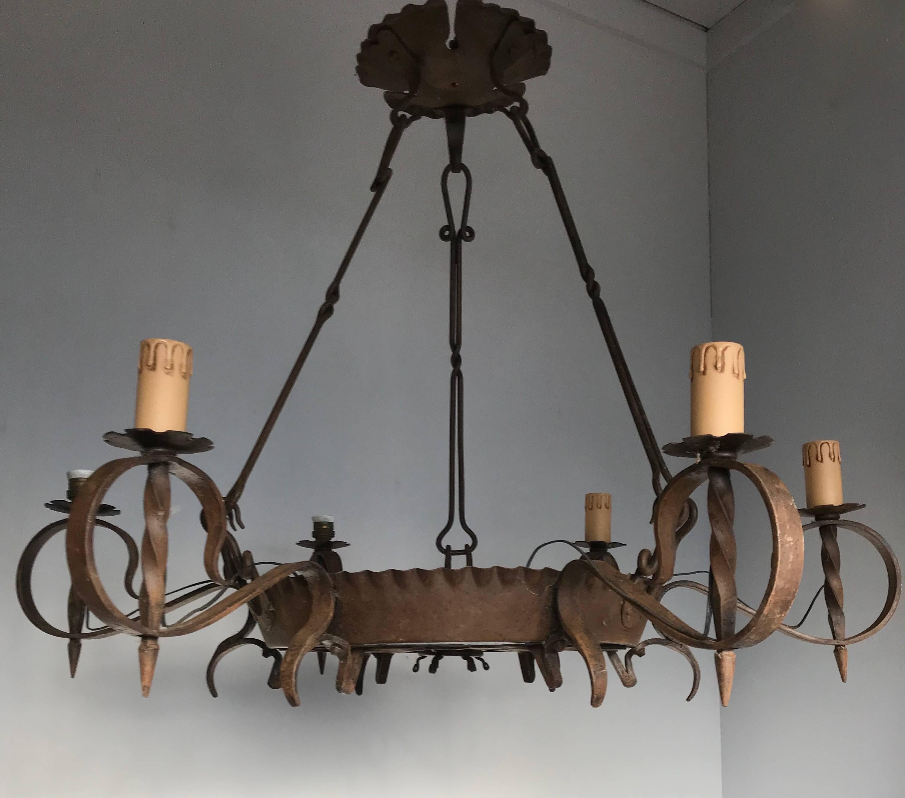 Large and round, forged in fire chandelier.

This large and all-handcrafted chandelier is another one of our recent great finds. The beautiful shape and the many details make this one of a kind chandelier an absolute joy to own and look at. Apart