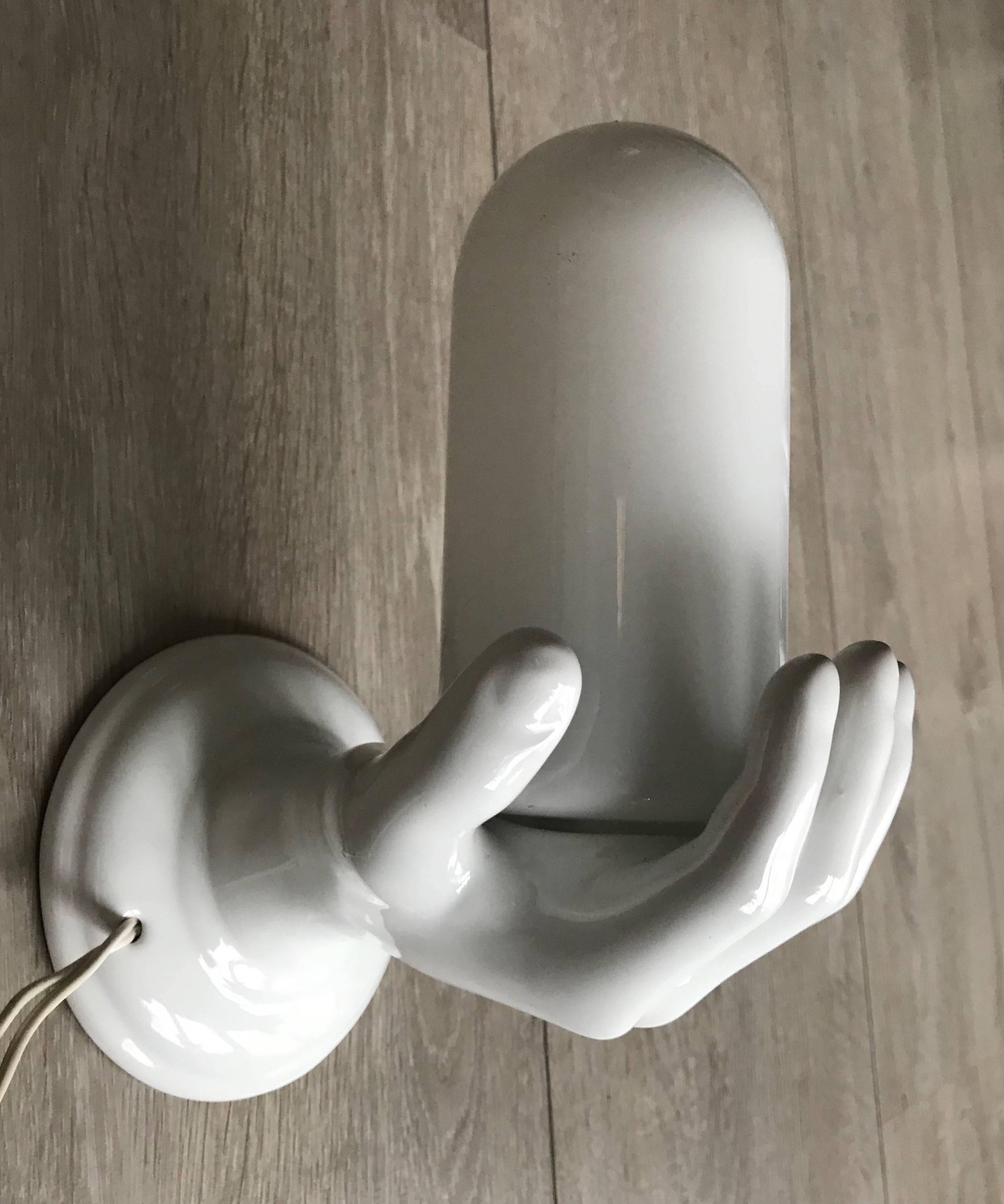 Good quality and fine condition hand sculpture wall light.  

If you are looking for an out of the ordinary wall light then this rare specimen could be just perfect for you. This midcentury sculptural ceramic wall light could be ideal for a hallway.