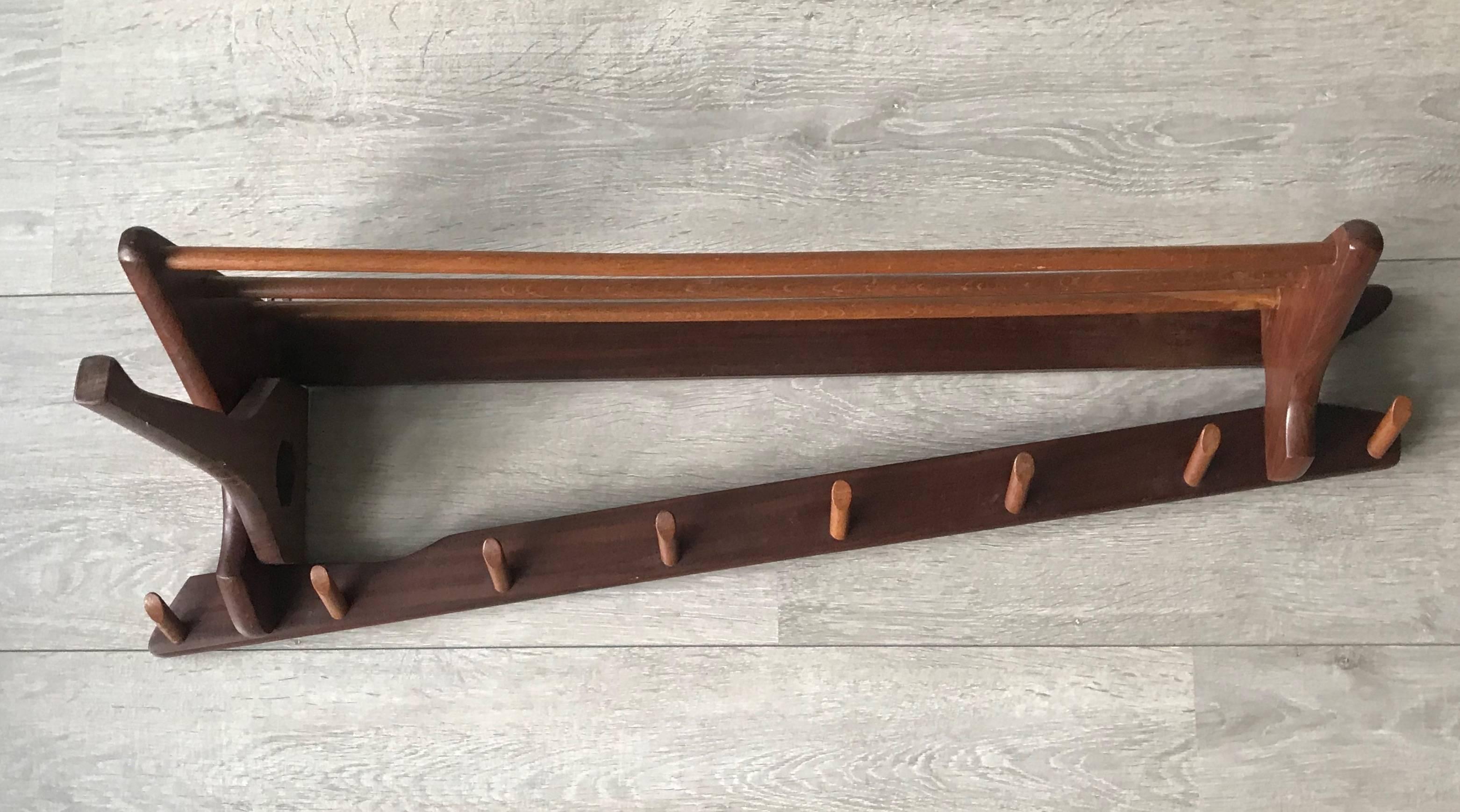 Great quality and condition midcentury wall coat rack. 

This beautifully designed, perfectly executed and highly practical midcentury coat rack could be the ideal piece to come home to. Thanks to the metal hooks on the back it is easy and safe to